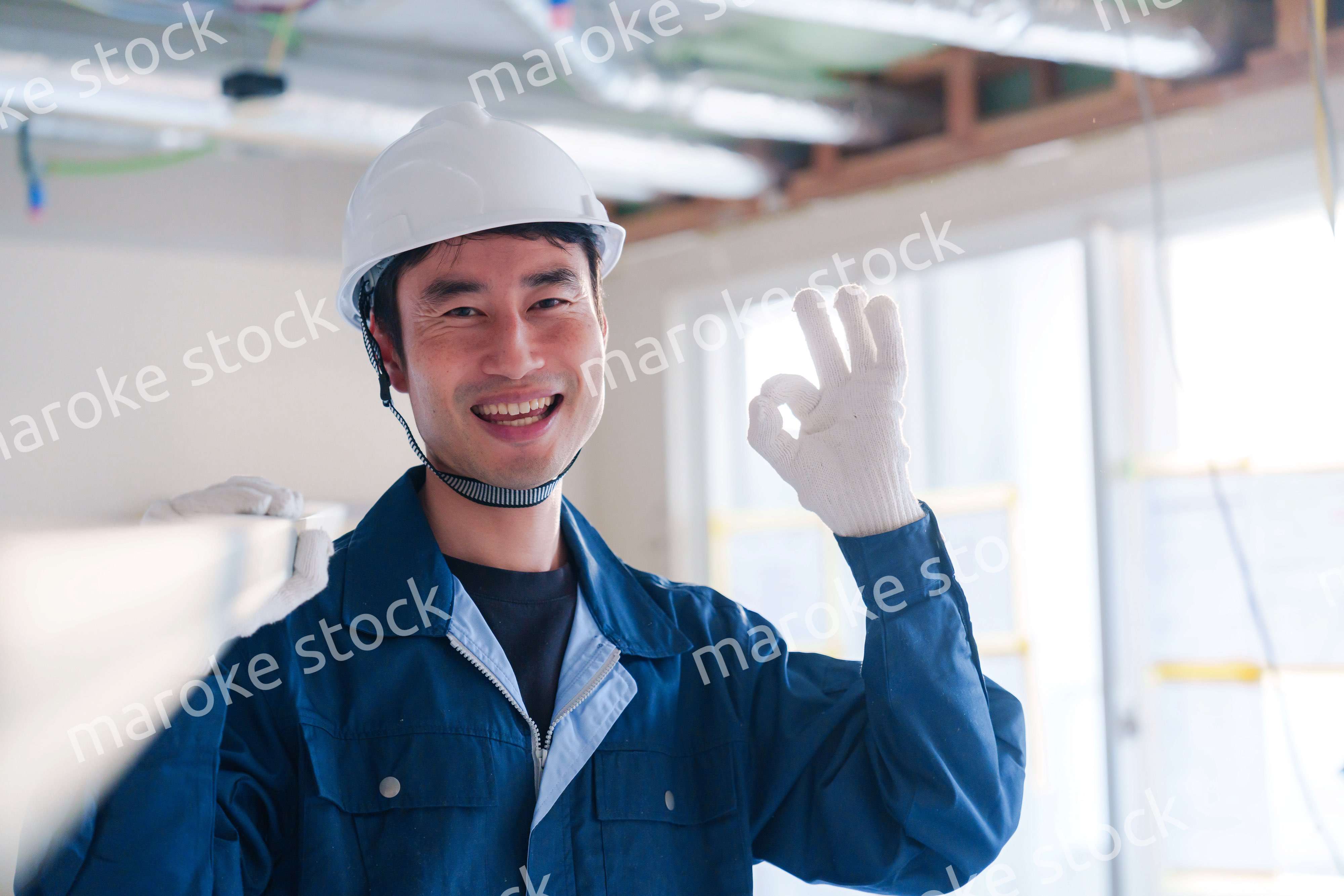 建設現場で資材を運ぶ男性の職人