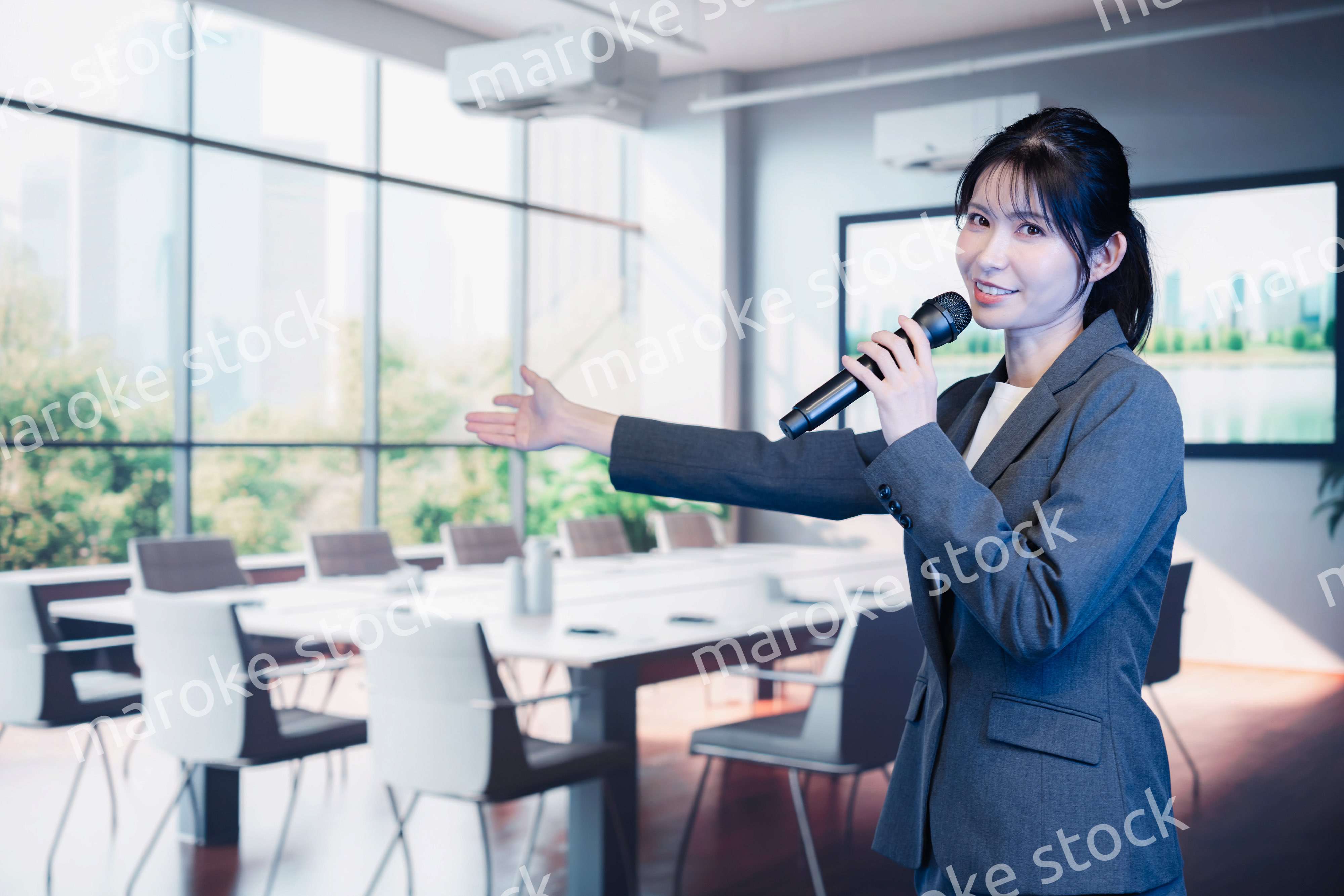 マイクで話すビジネスウーマン