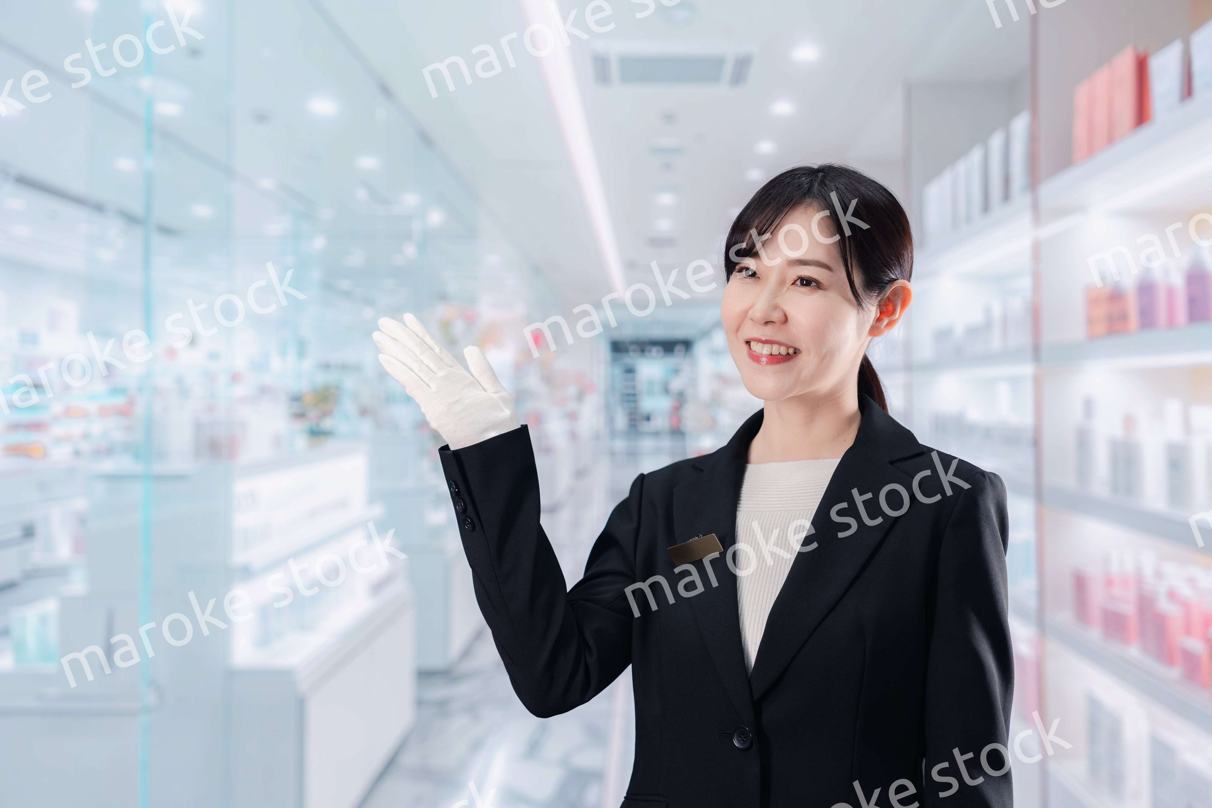 化粧品売り場で接客をする若い女性