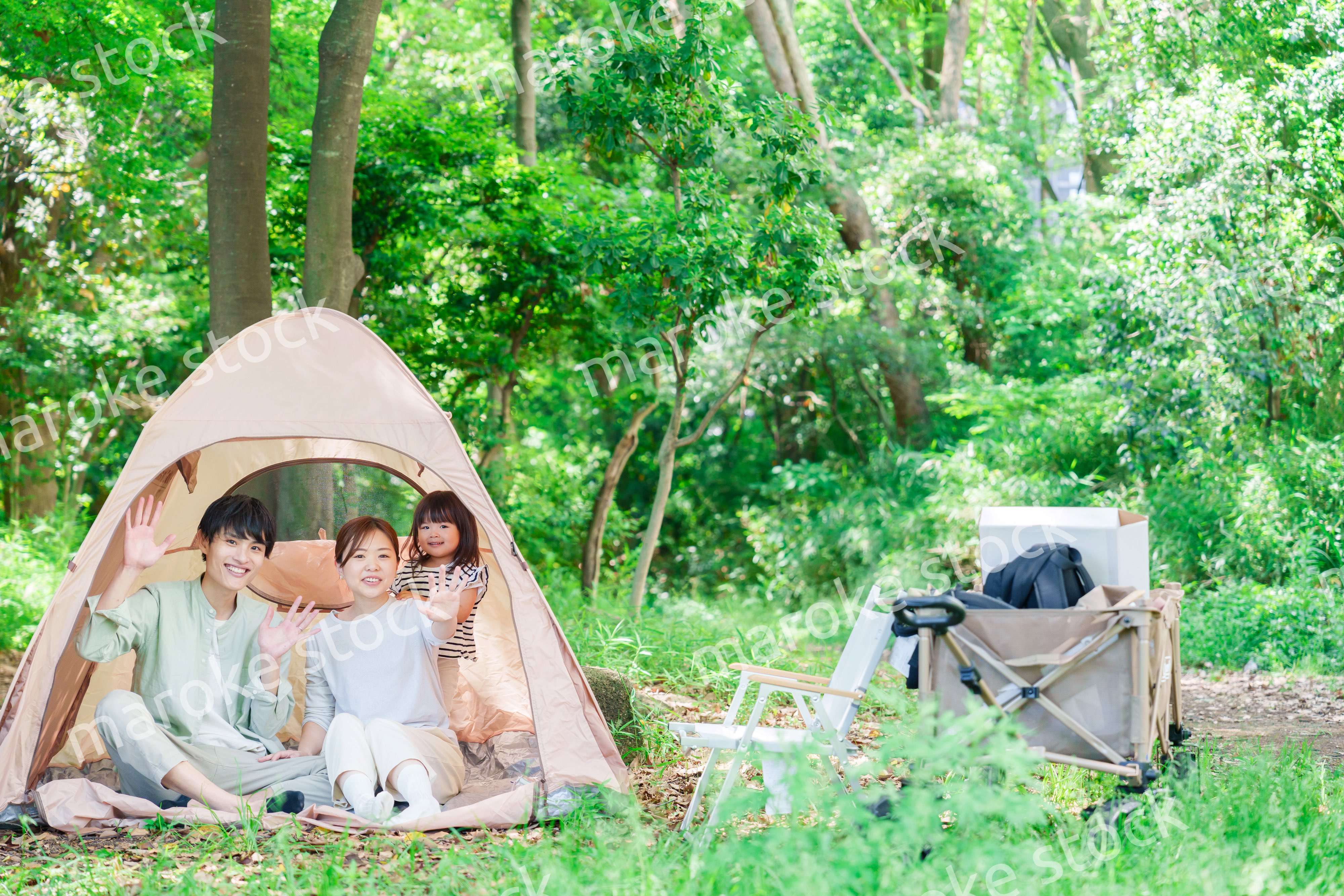 森の中でキャンプを楽しむ子供連れのファミリー