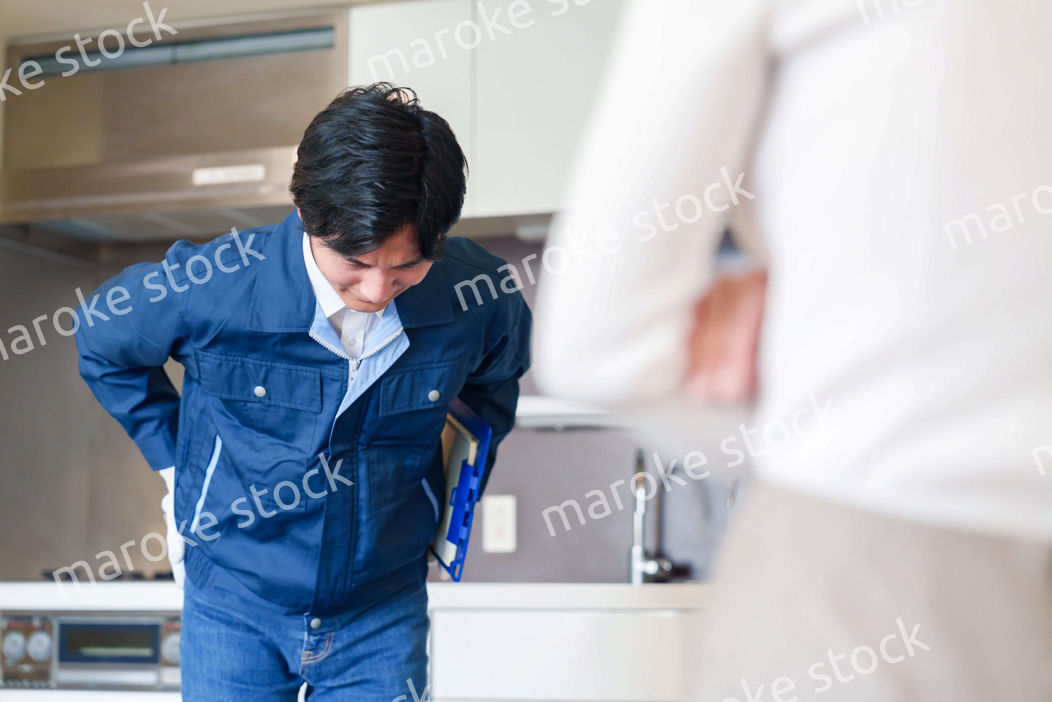 お客様に頭を下げてお詫びをする作業員の男性