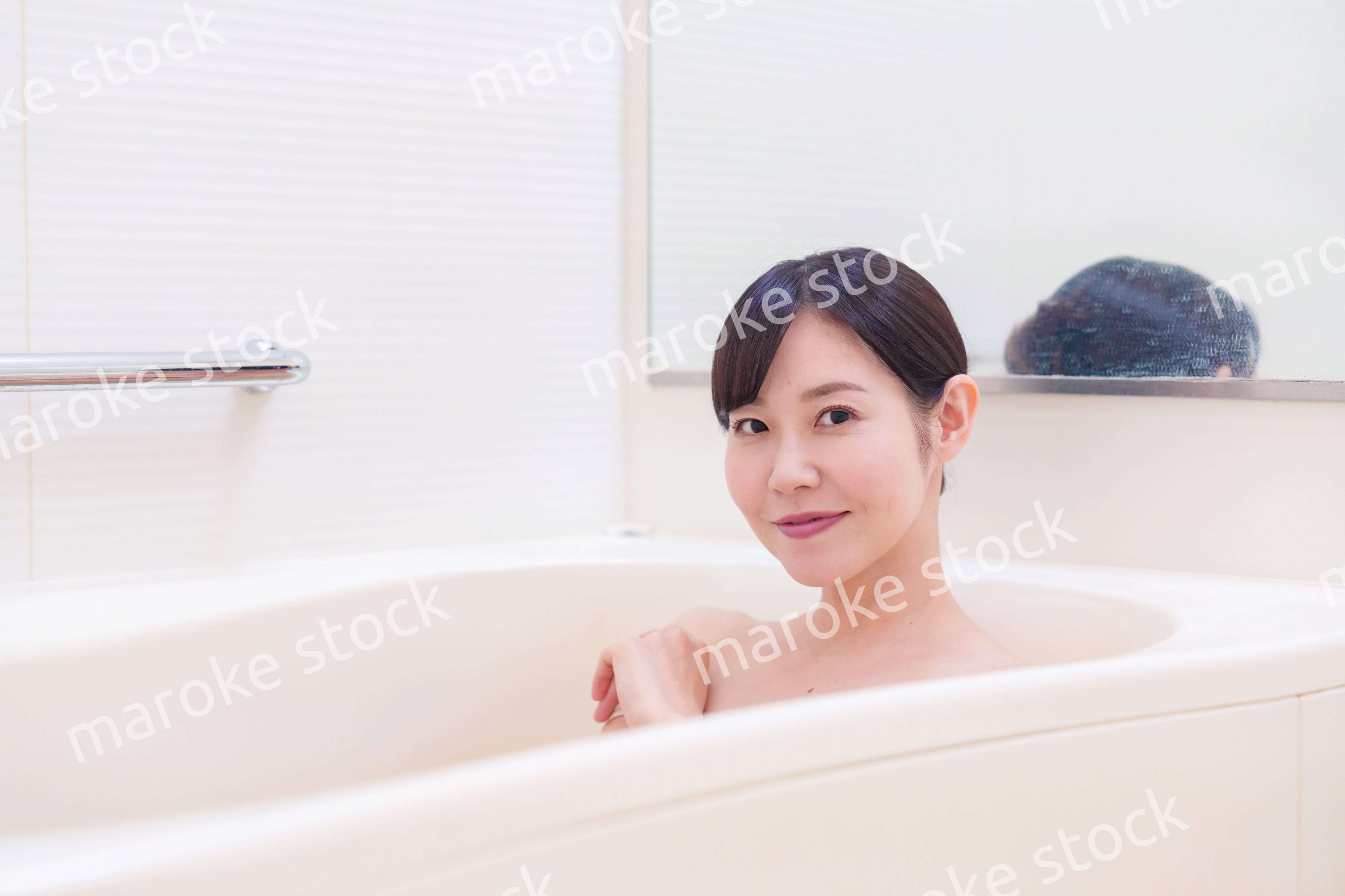 家のお風呂に入ってゆっくりとリラックスをするミドルの女性