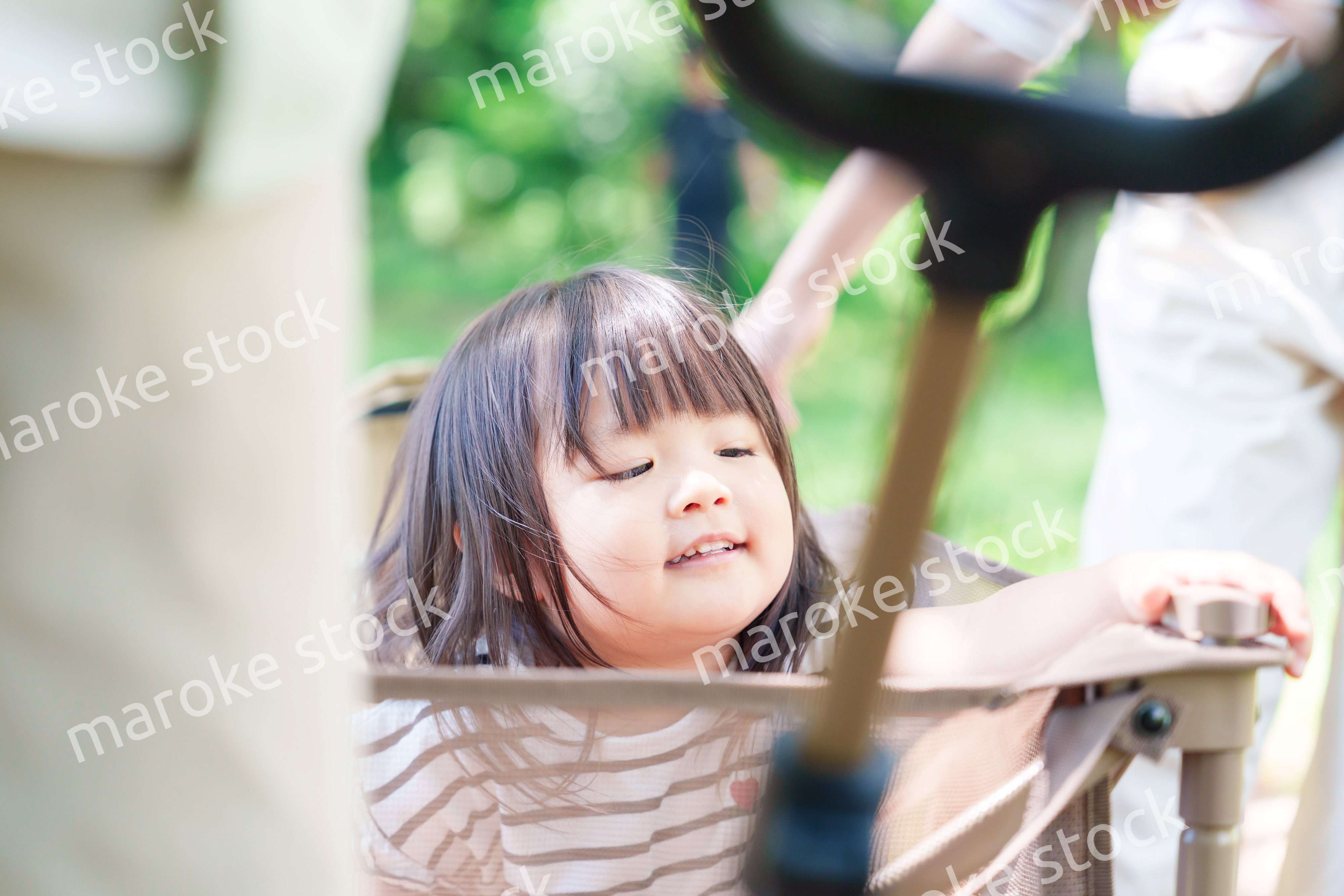 カートに乗って喜ぶ小さな女の子