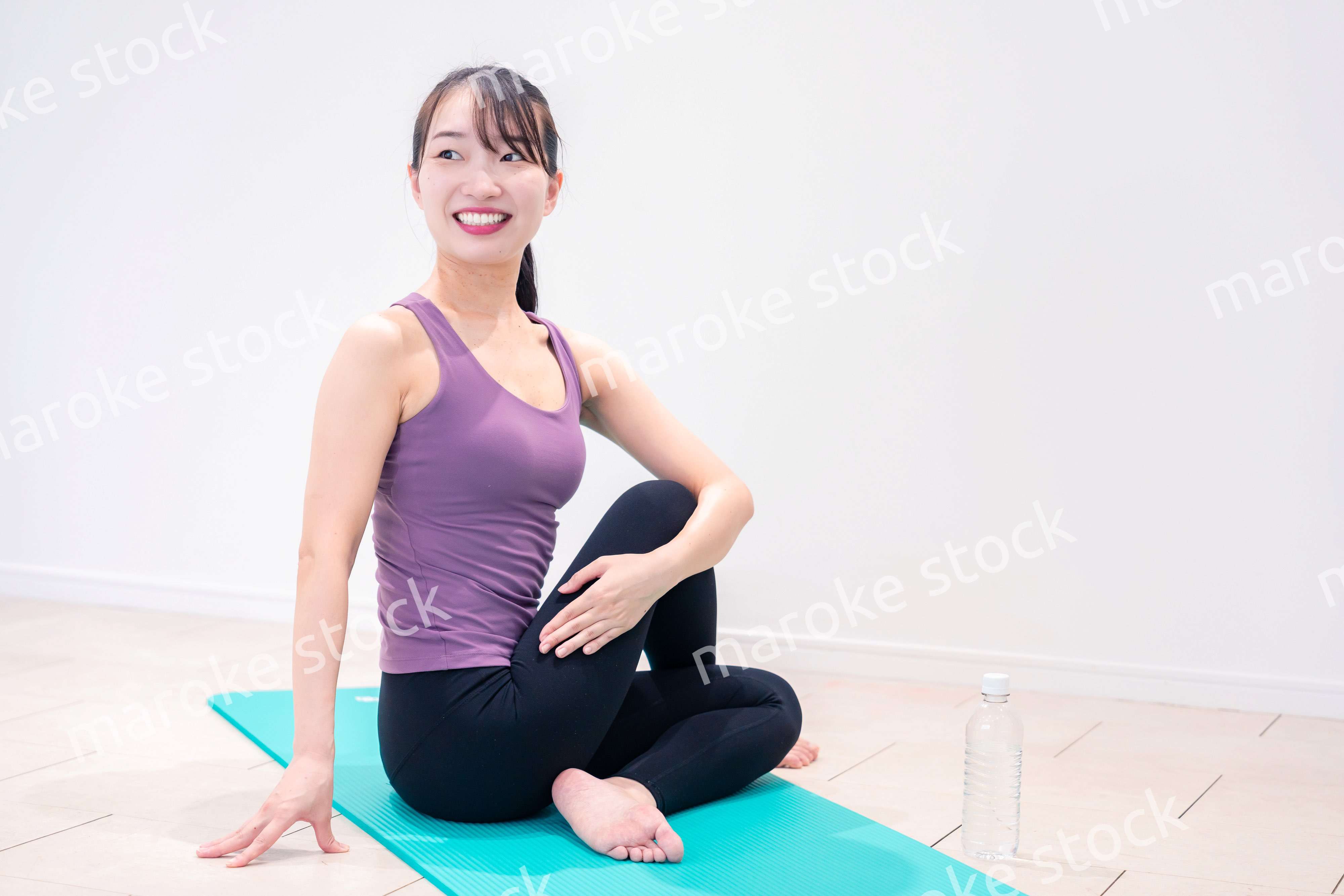 ジムでヨガコーチをするスポーティーな女性