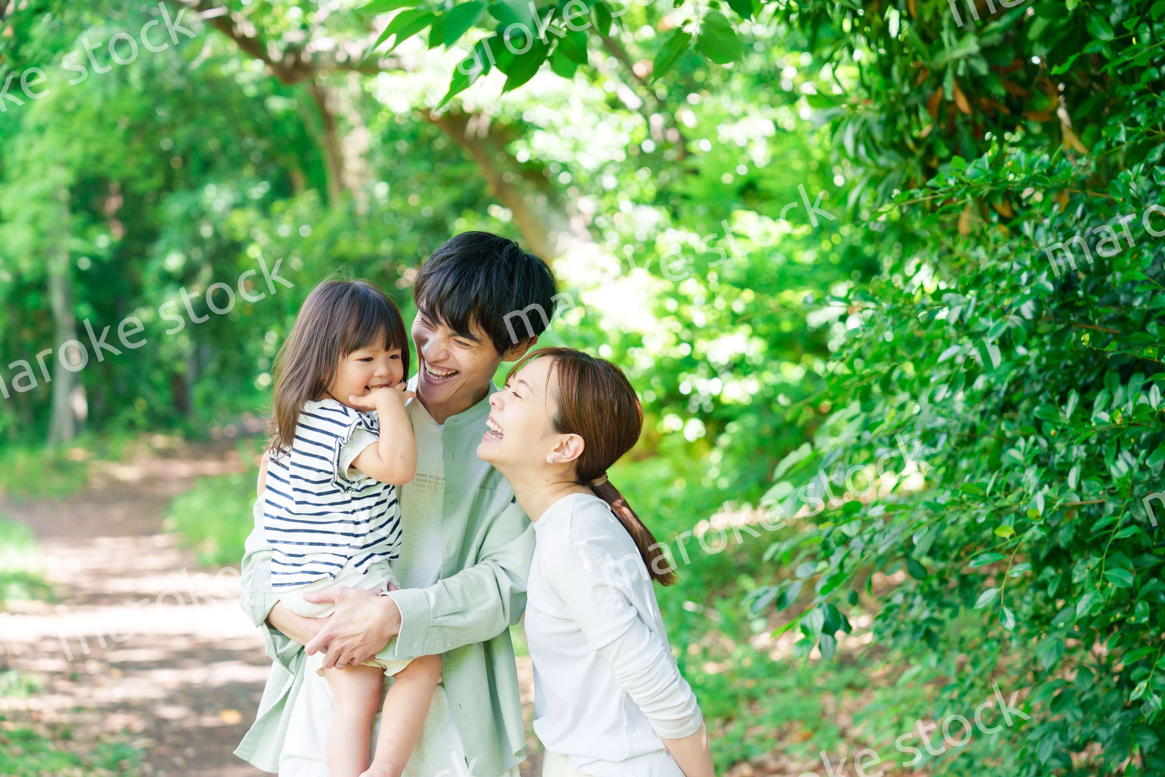 自然の中を歩いてアウトドアを楽しむ若いファミリー