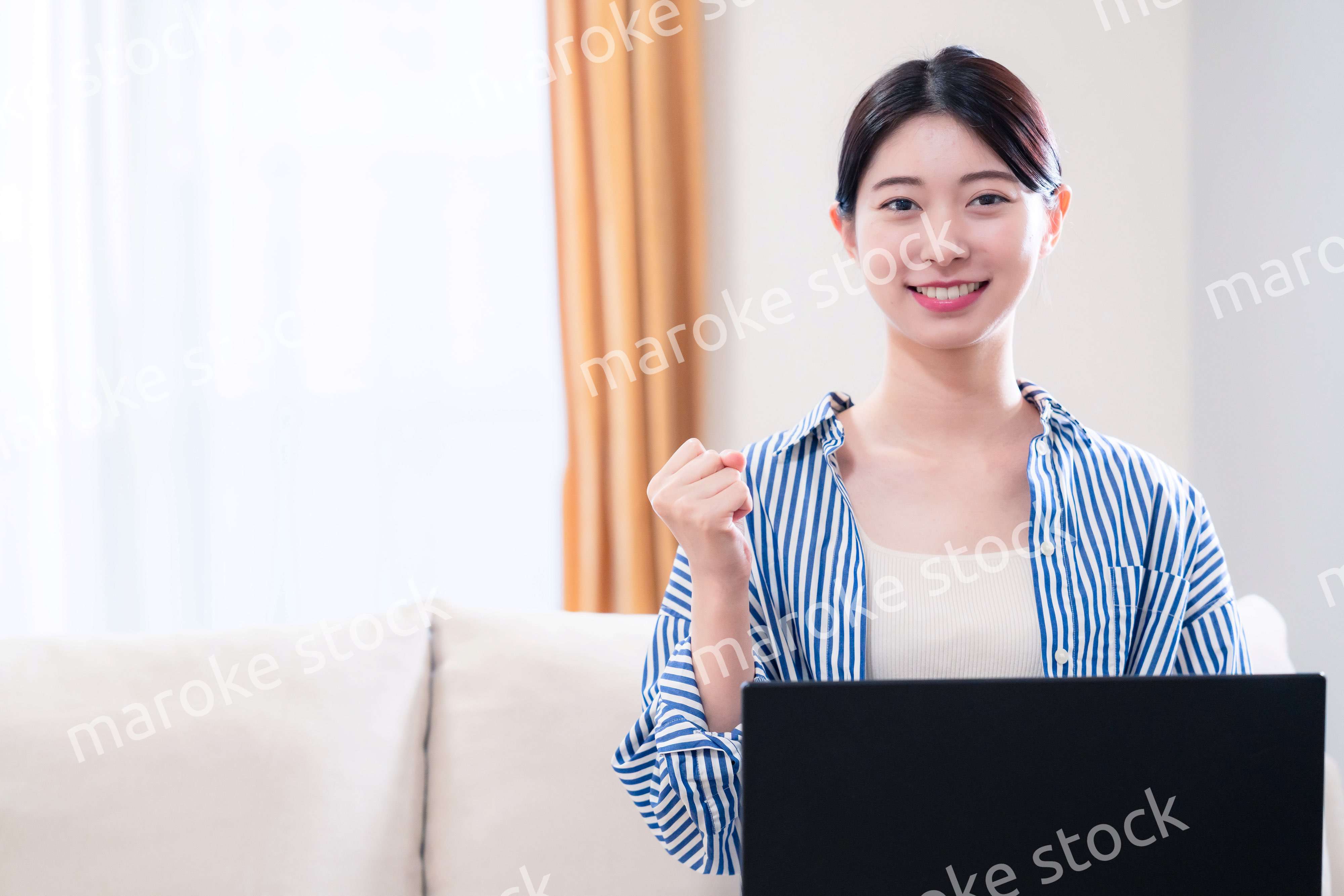 家でリラックスをしてパソコンを使う若い女性