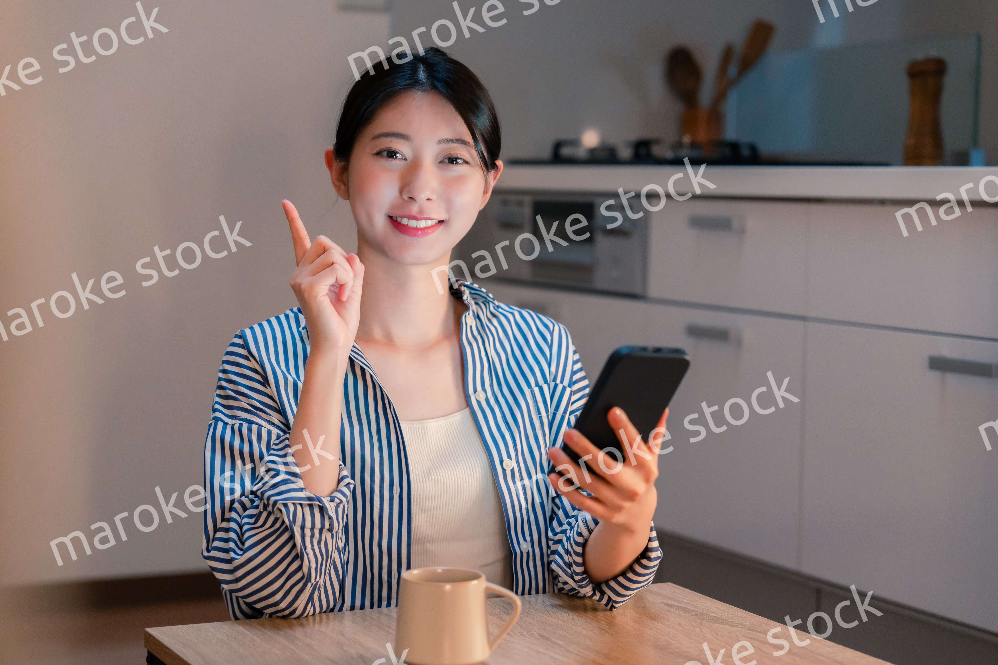 夜遅くに笑顔でスマホを使う若い女性