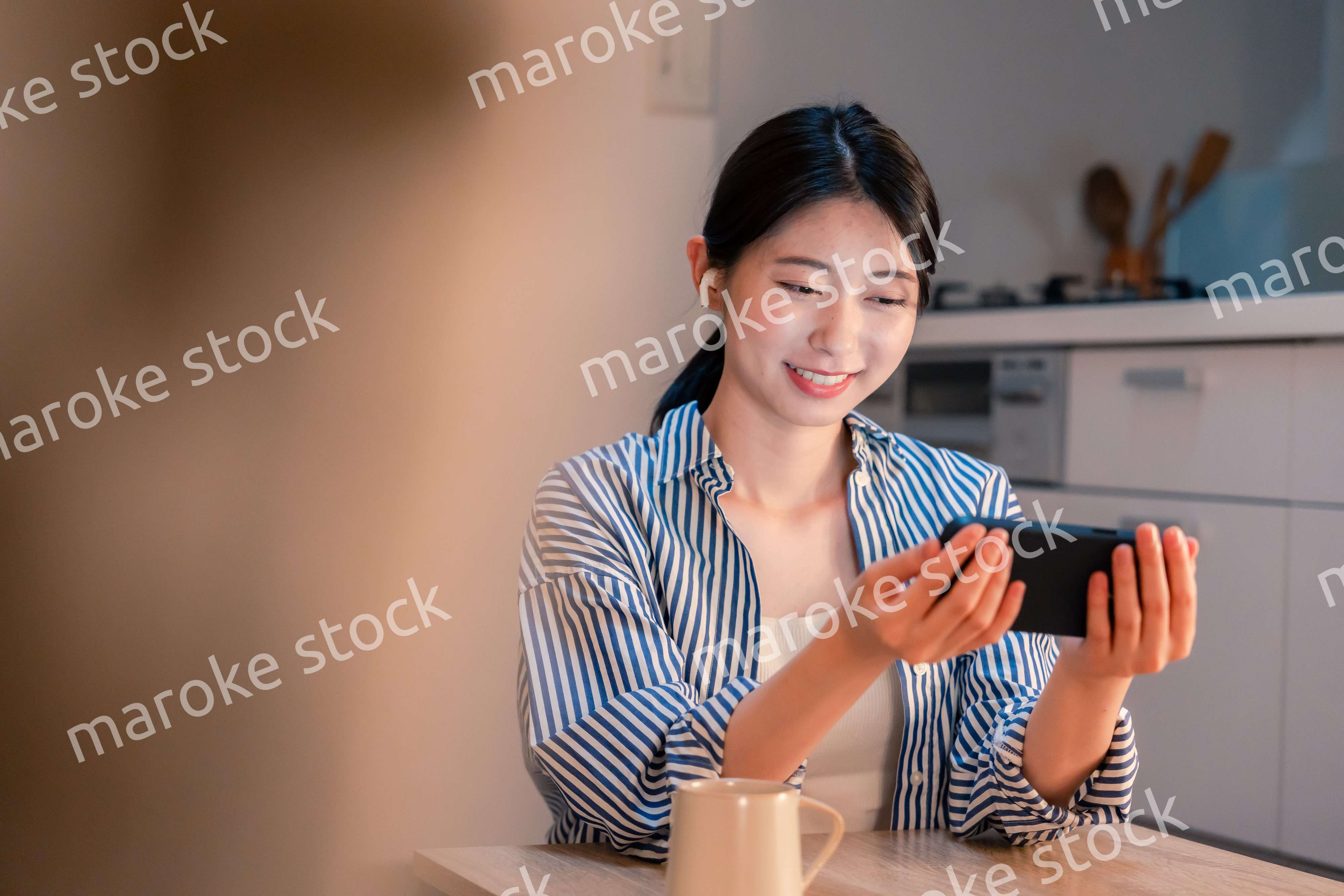 夜にスマホでコンテンツを楽しむ一人暮らしの女性