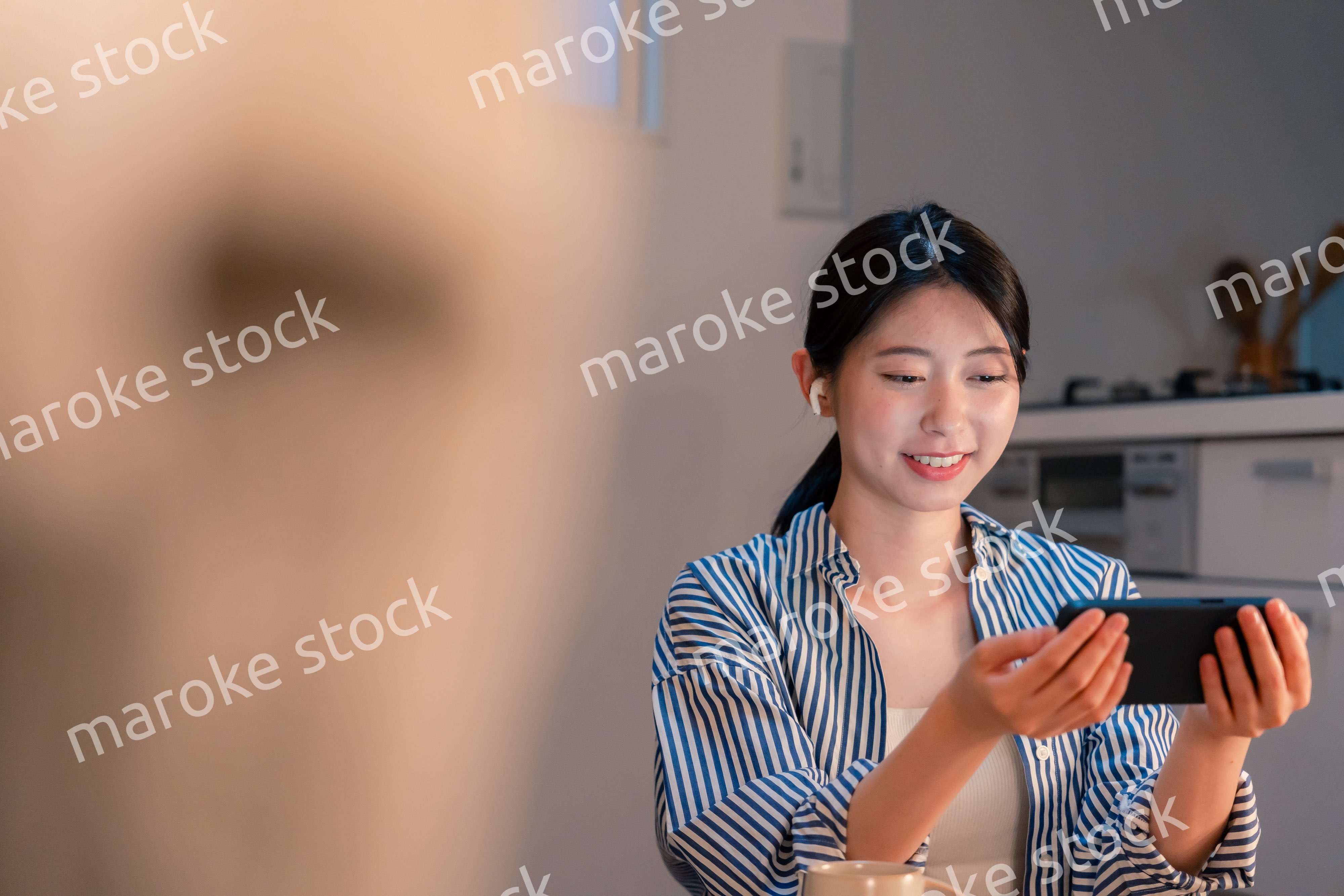 夜にスマホでコンテンツを楽しむ一人暮らしの女性