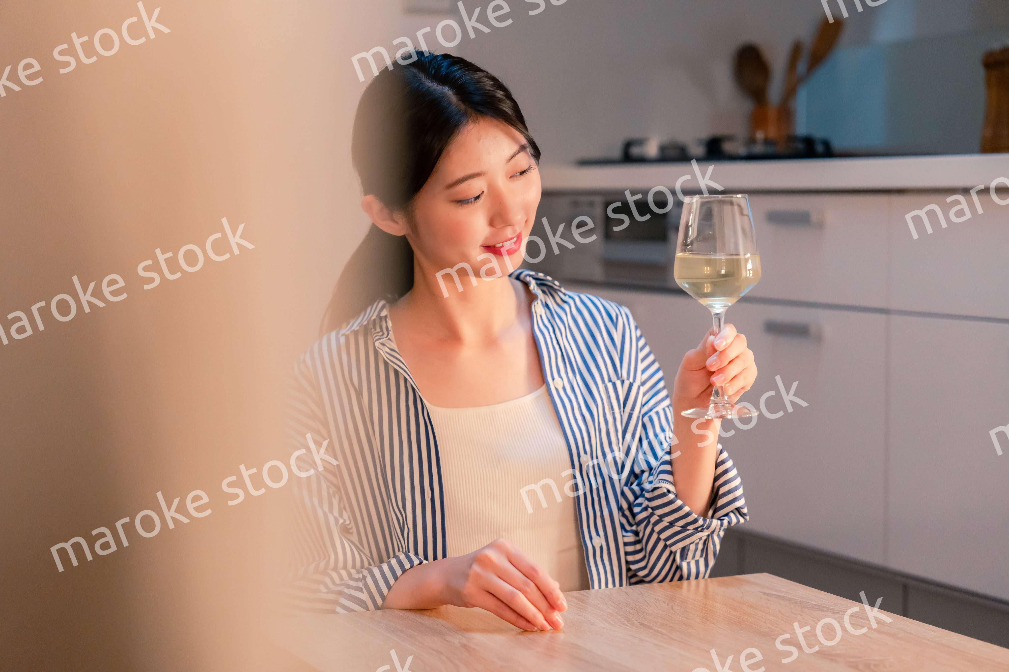 家でワインを楽しむ一人暮らしの女性
