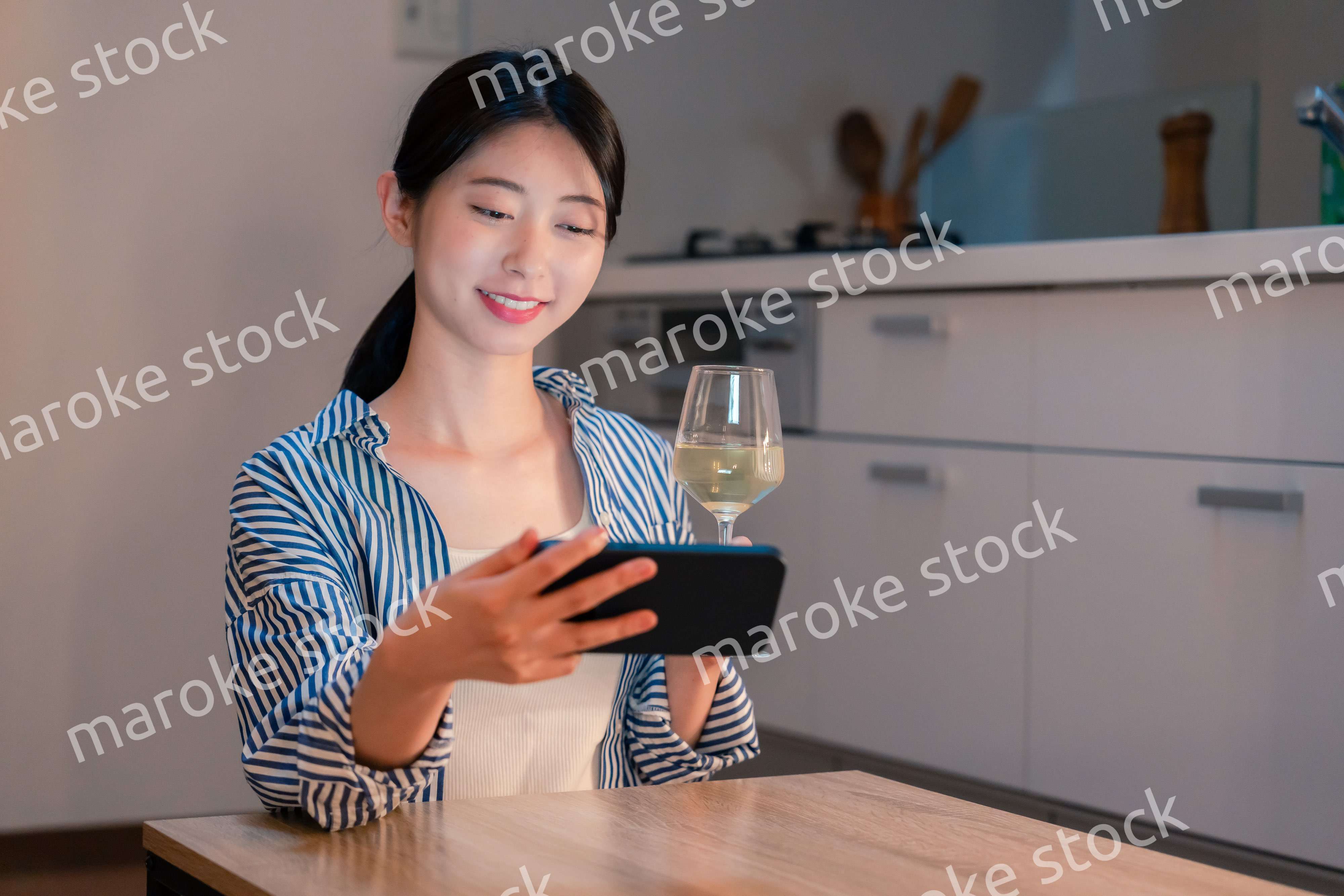 夜に一人で晩酌をする若い女性