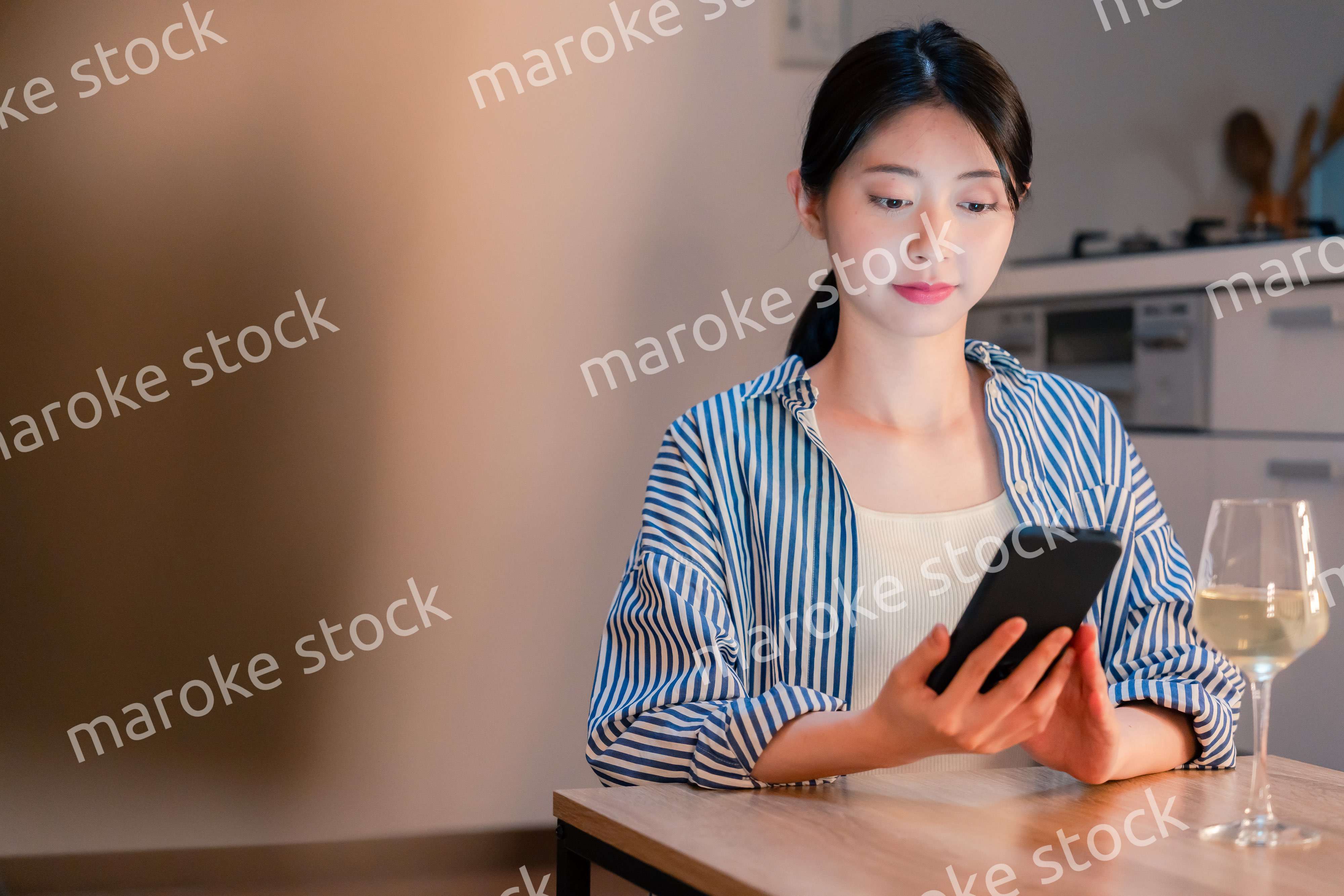 夜に一人で晩酌をする若い女性