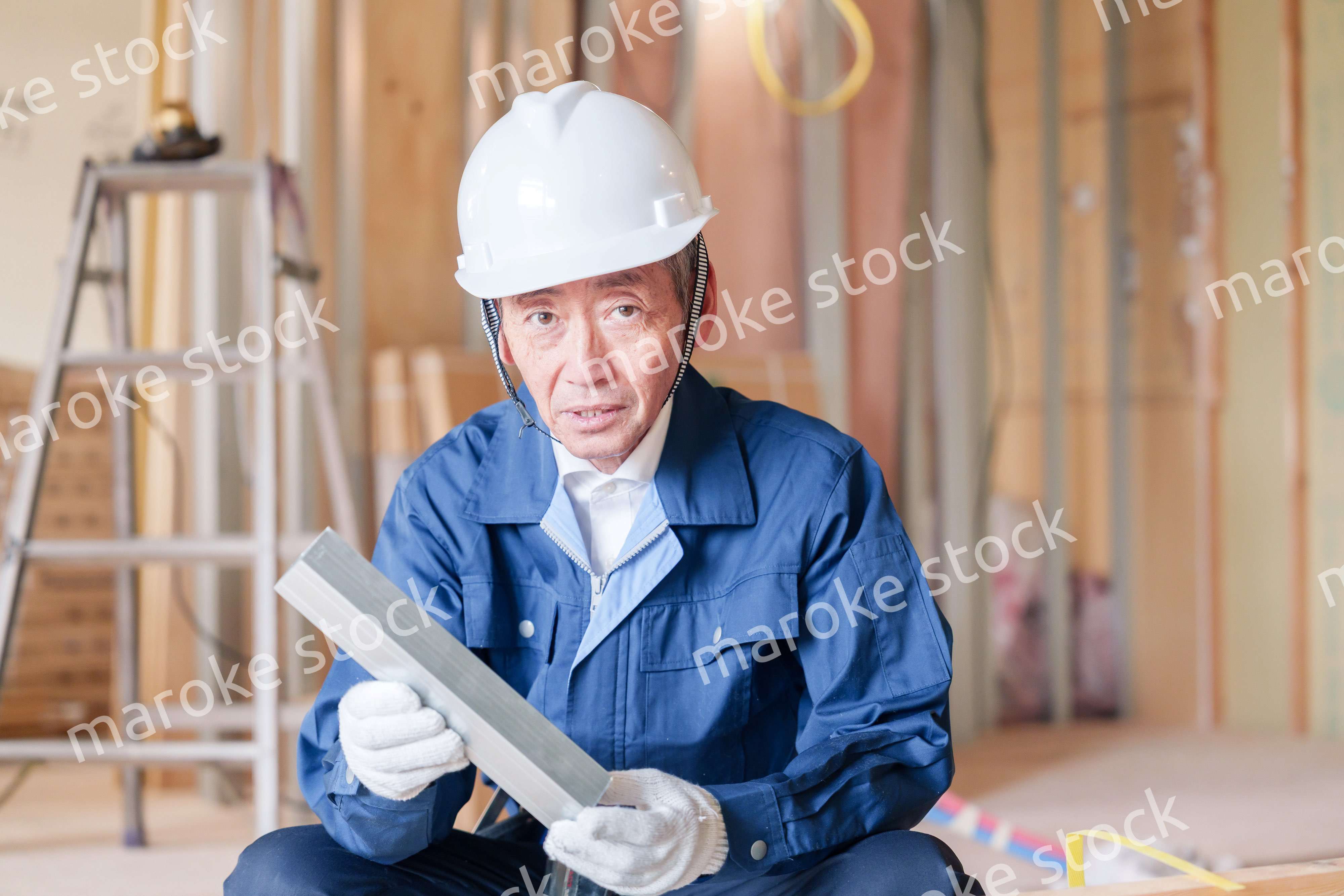 建設現場で軽量鉄骨の確認をする男性の職人