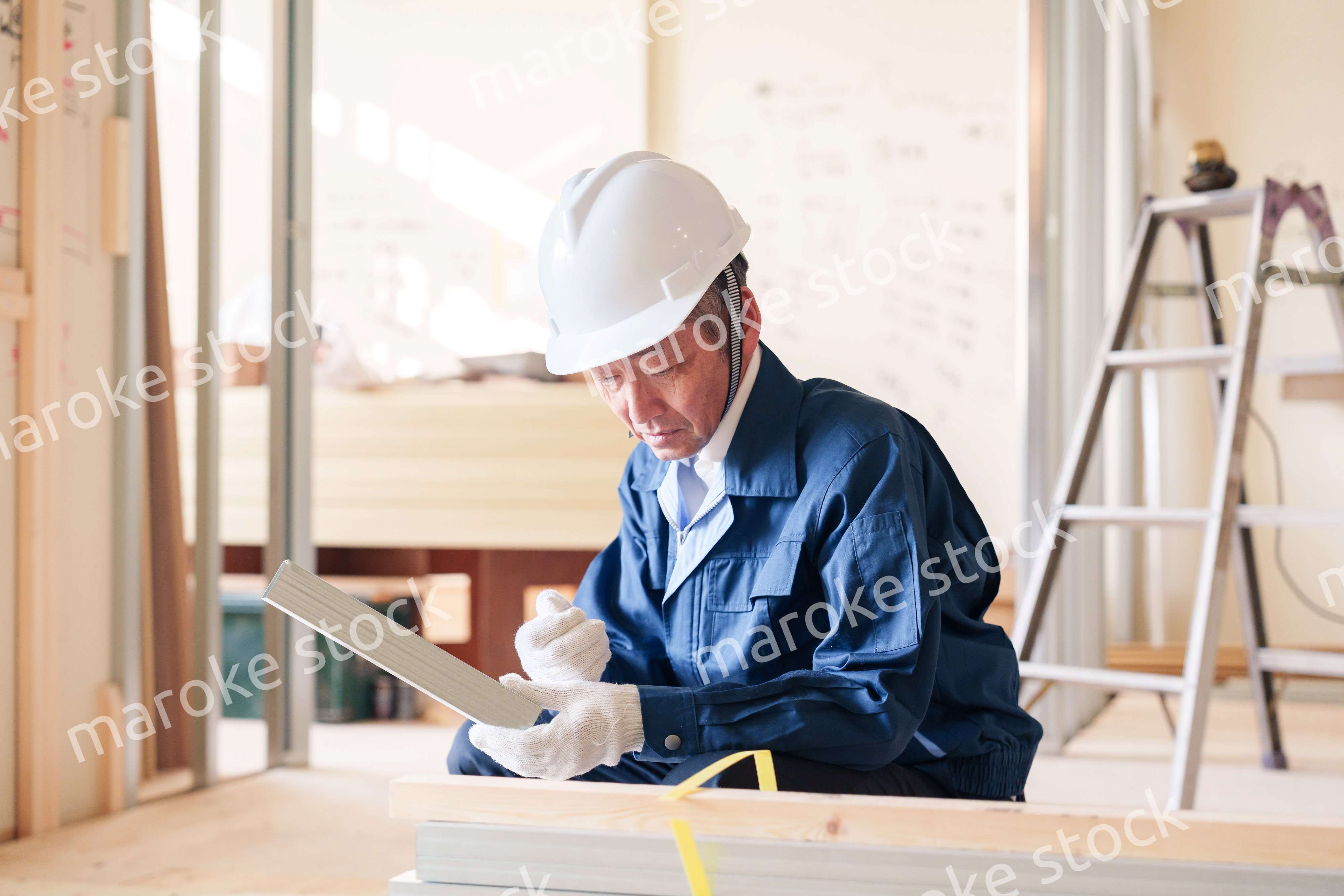 建設現場で軽量鉄骨の確認をする男性の職人