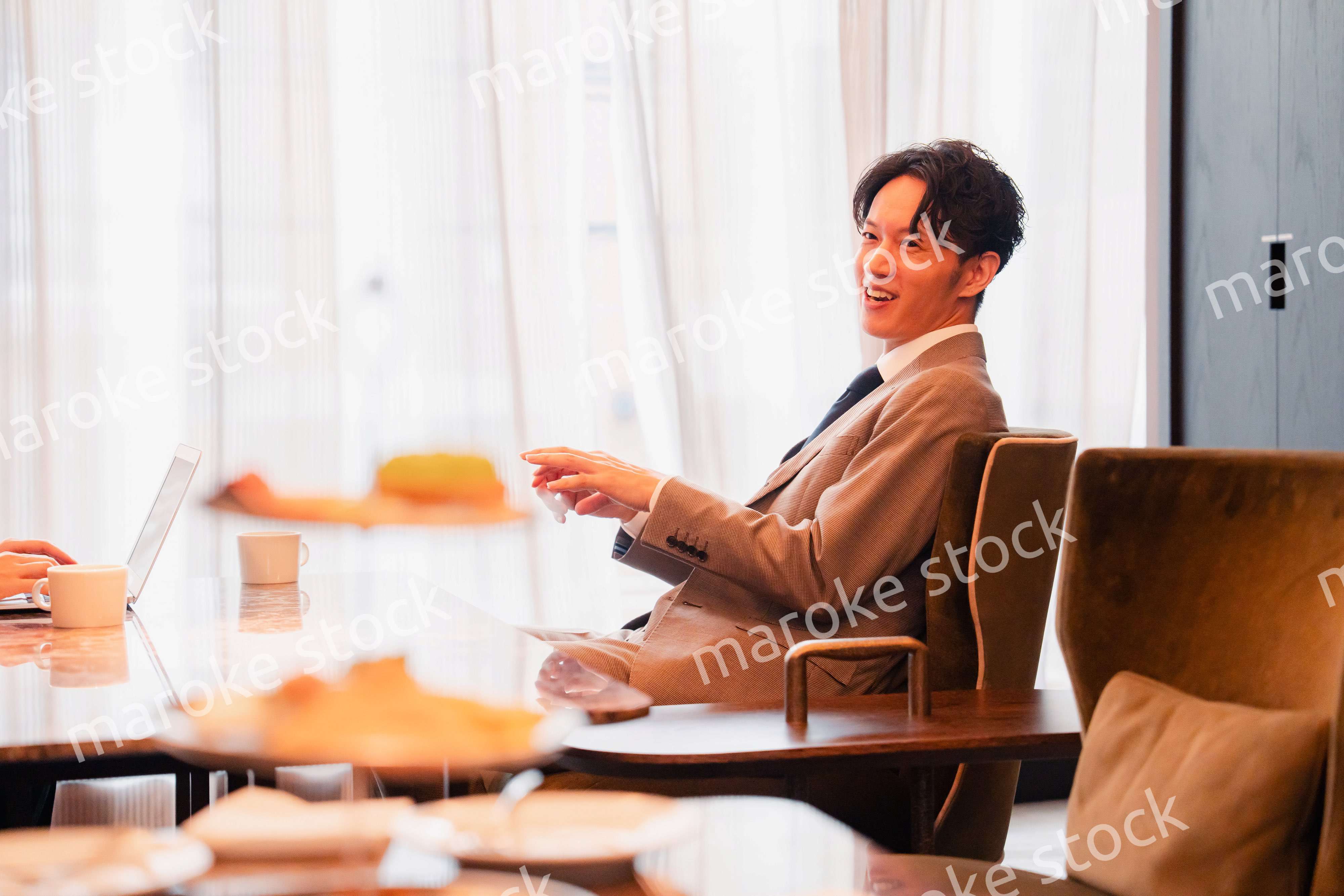 ホテルのラウンジでビジネスミーティングをする人々