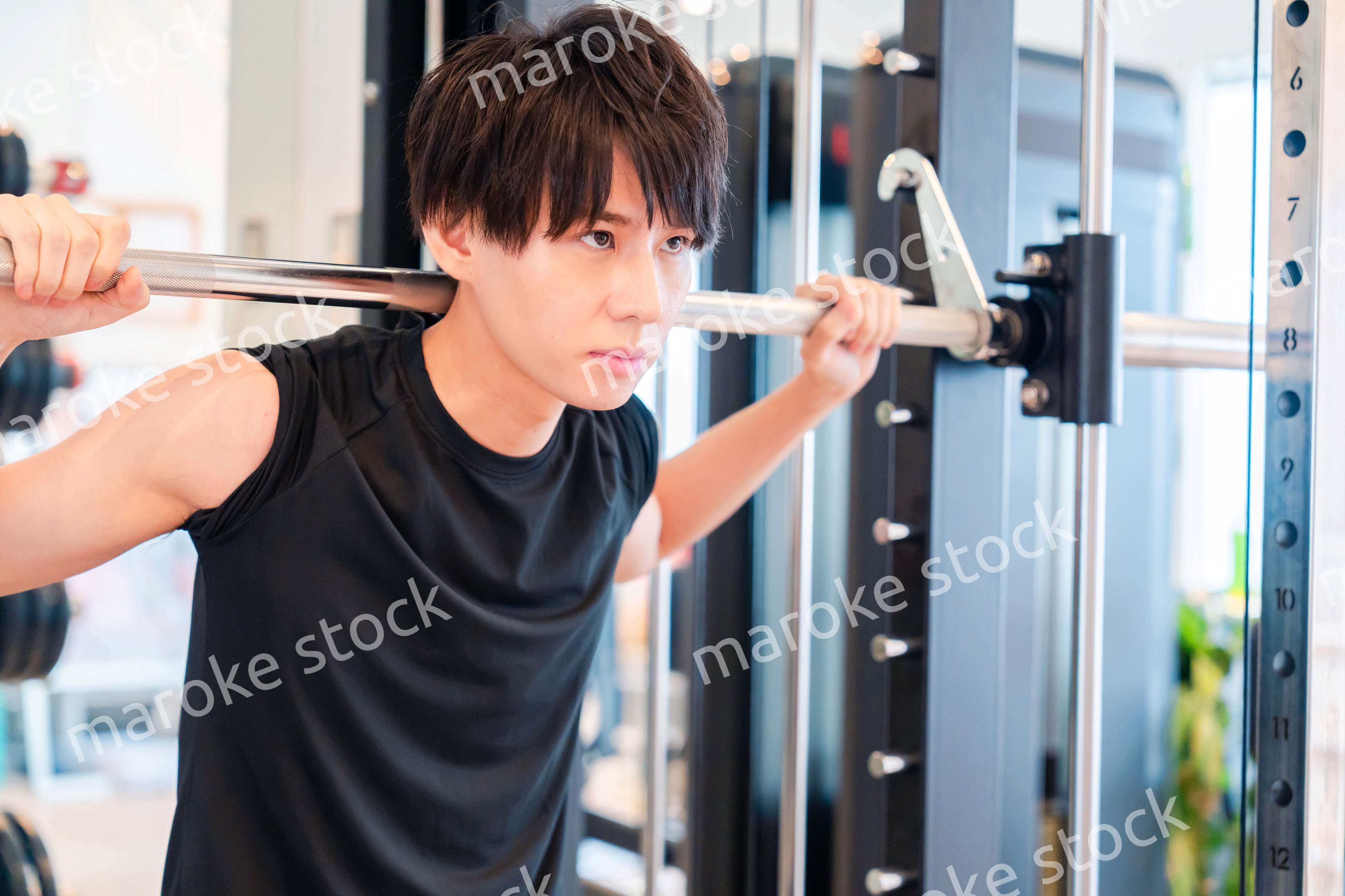 ジムで筋トレをする若い男性