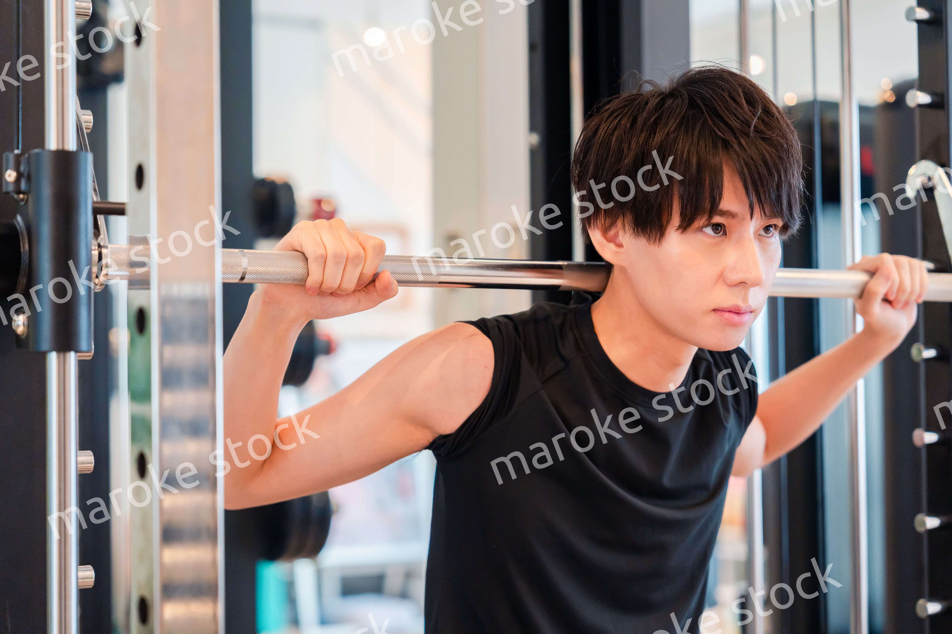 ジムで筋トレをする若い男性