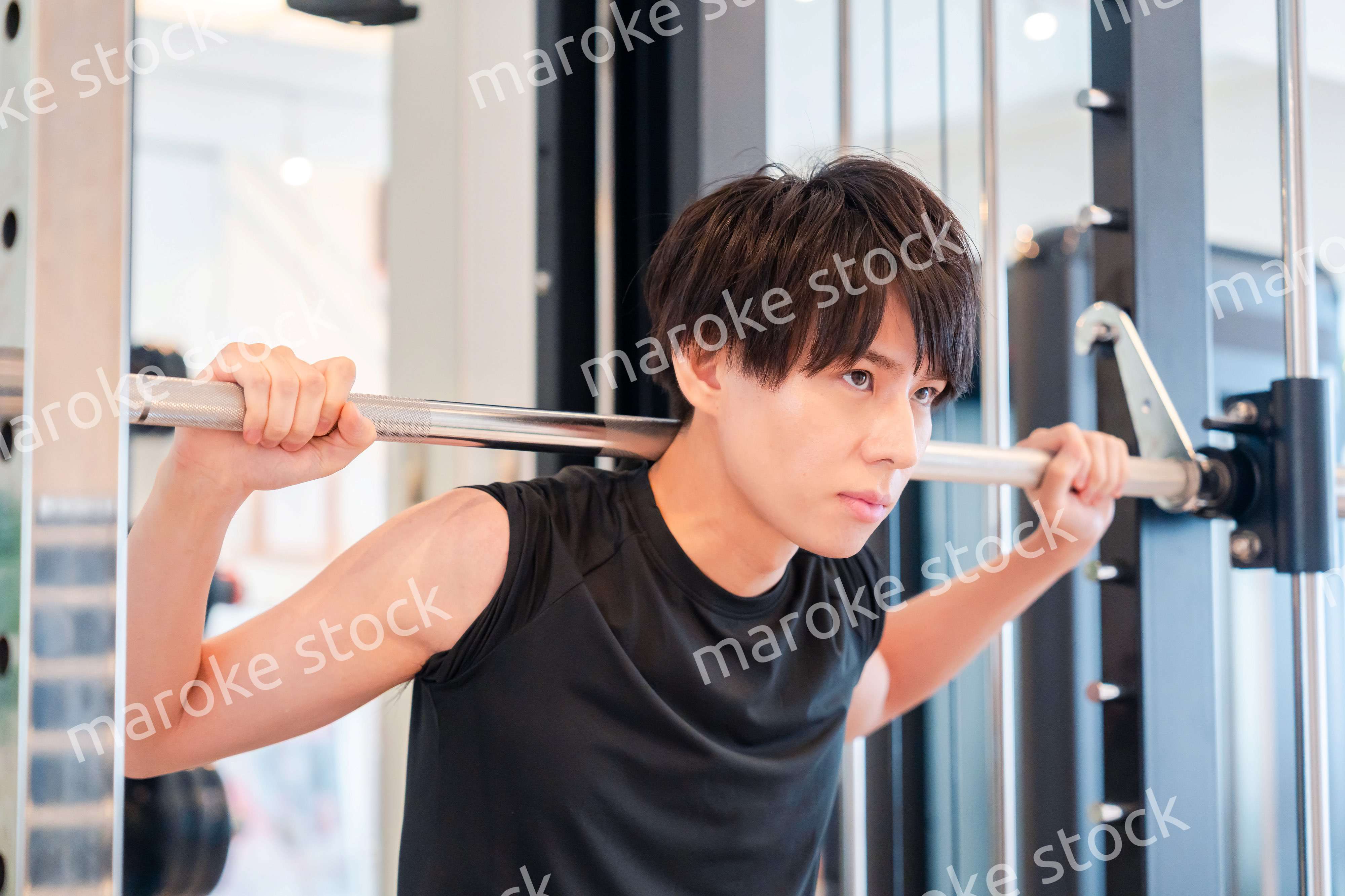 ジムで筋トレをする若い男性