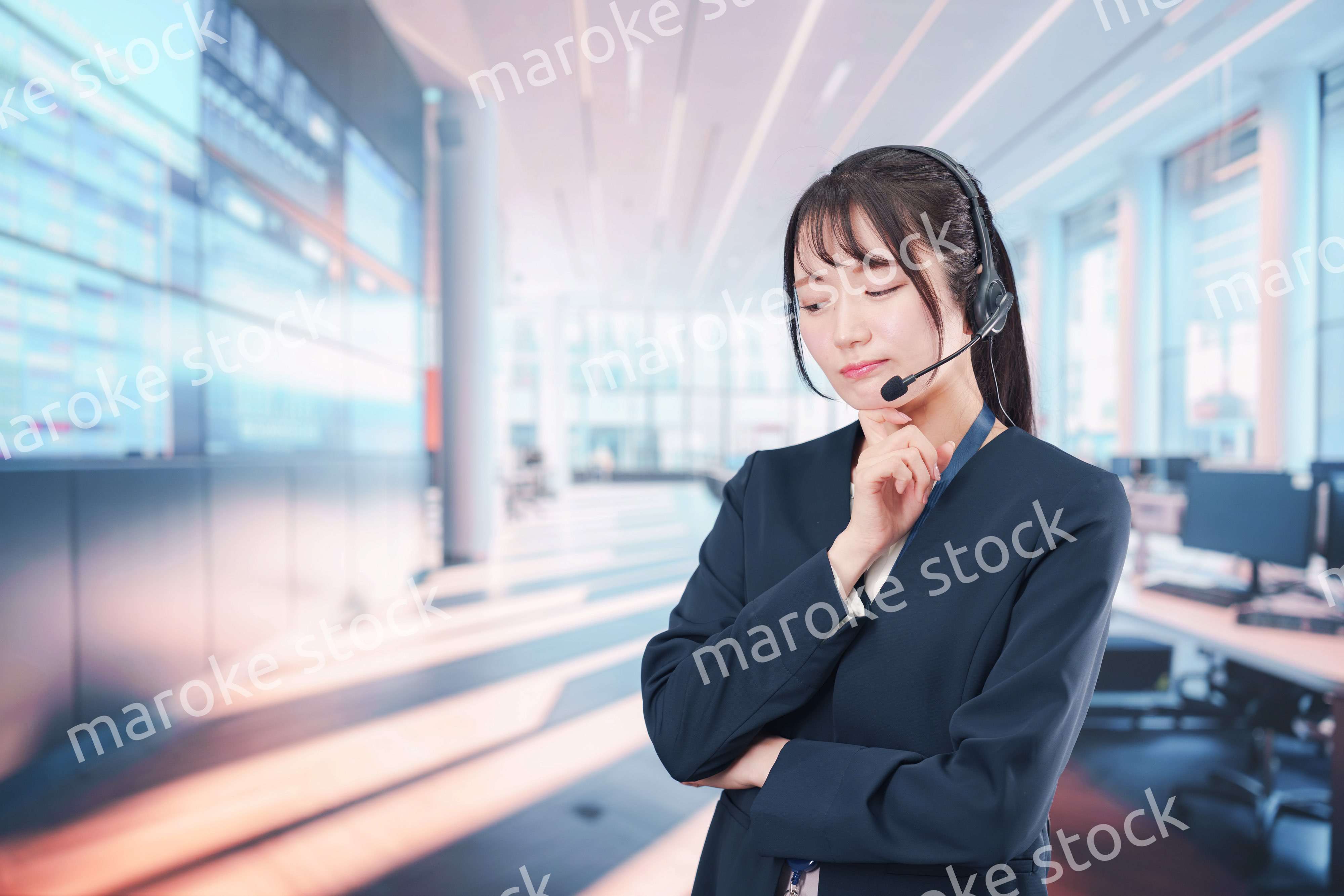 困った表情をする電話オペレータの女性