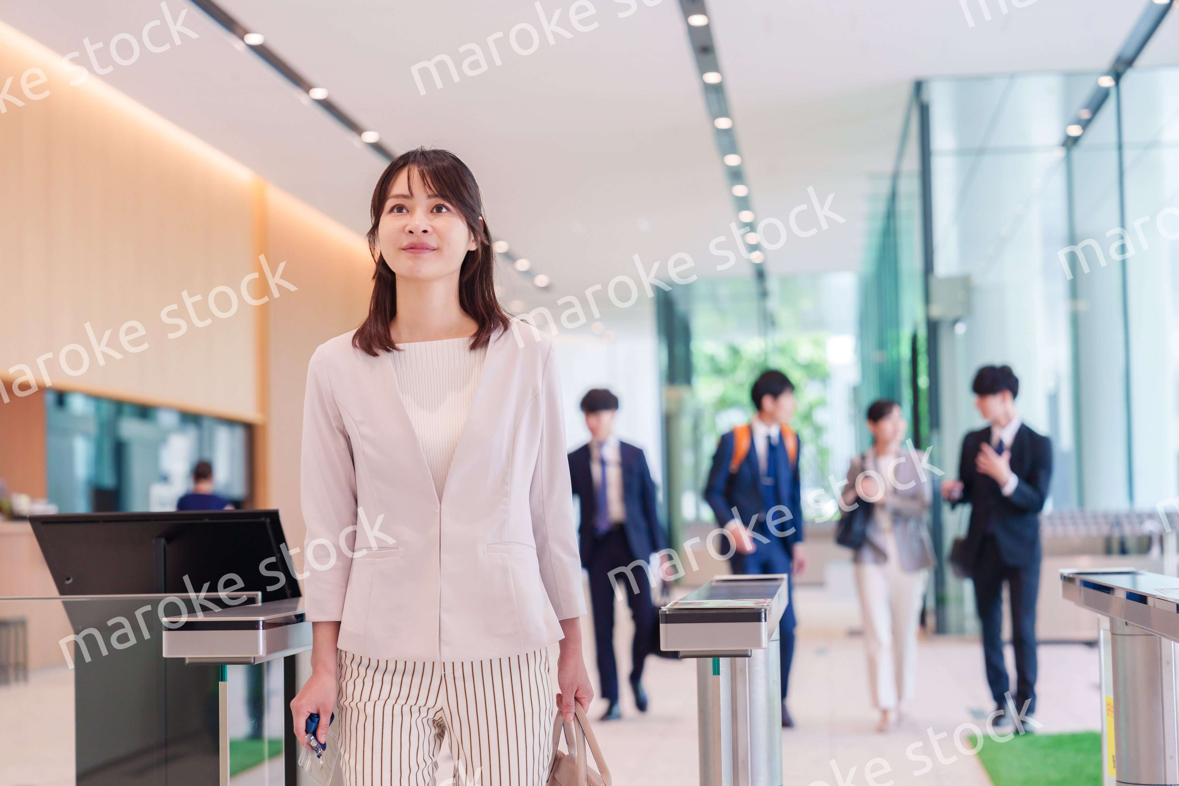 オフィスのセキュリティゲートを通るビジネスウーマン