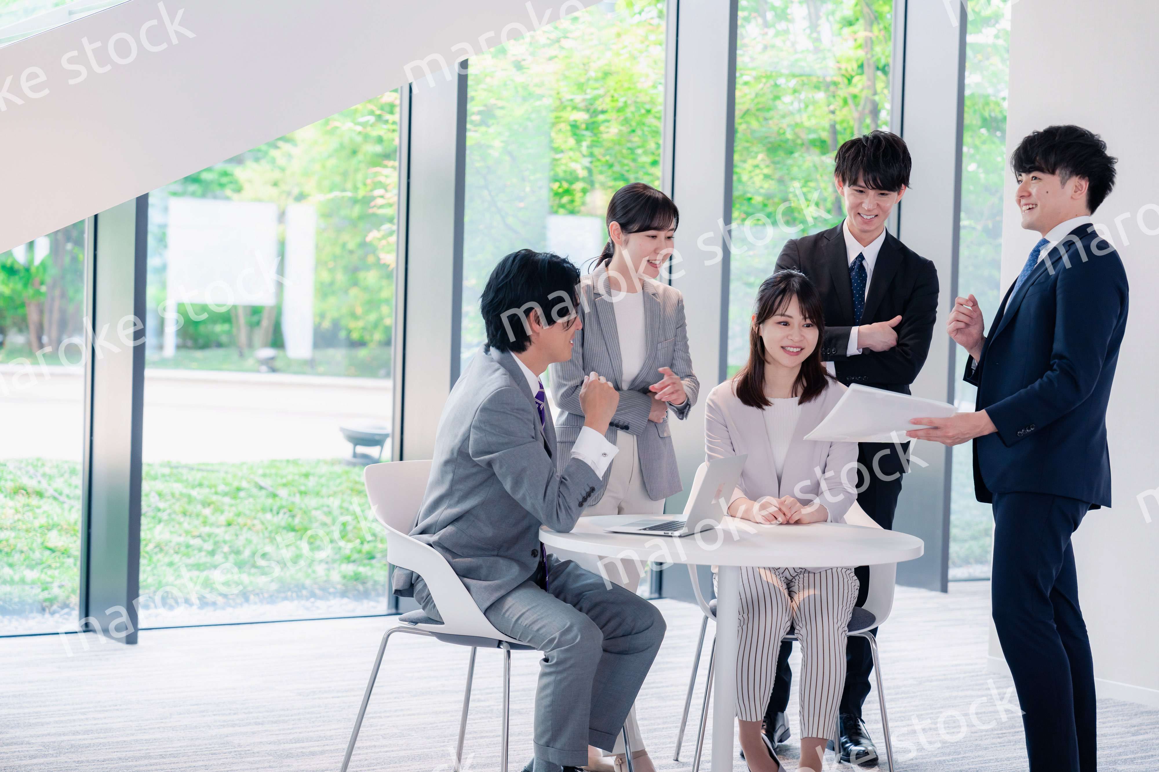 オフィスで笑顔で打ち合わせをするビジネスパーソン