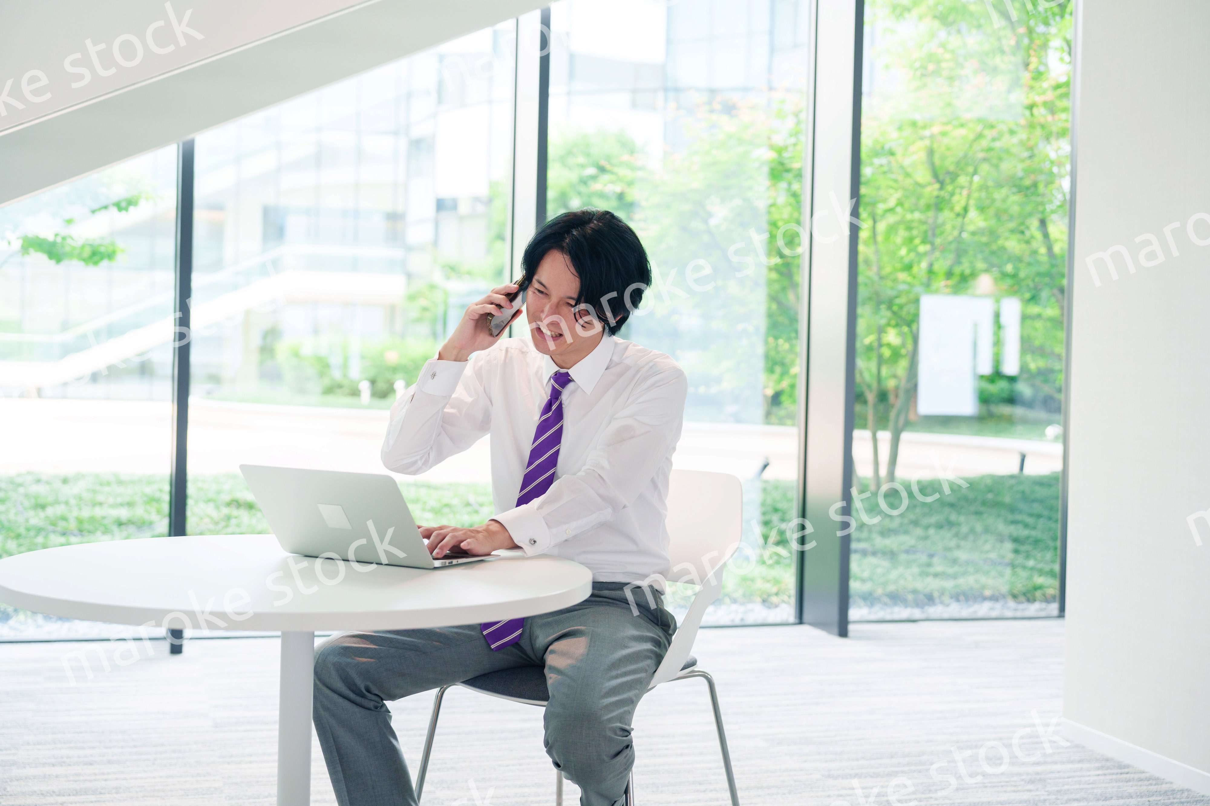 不機嫌な表情で電話をするビジネスマン