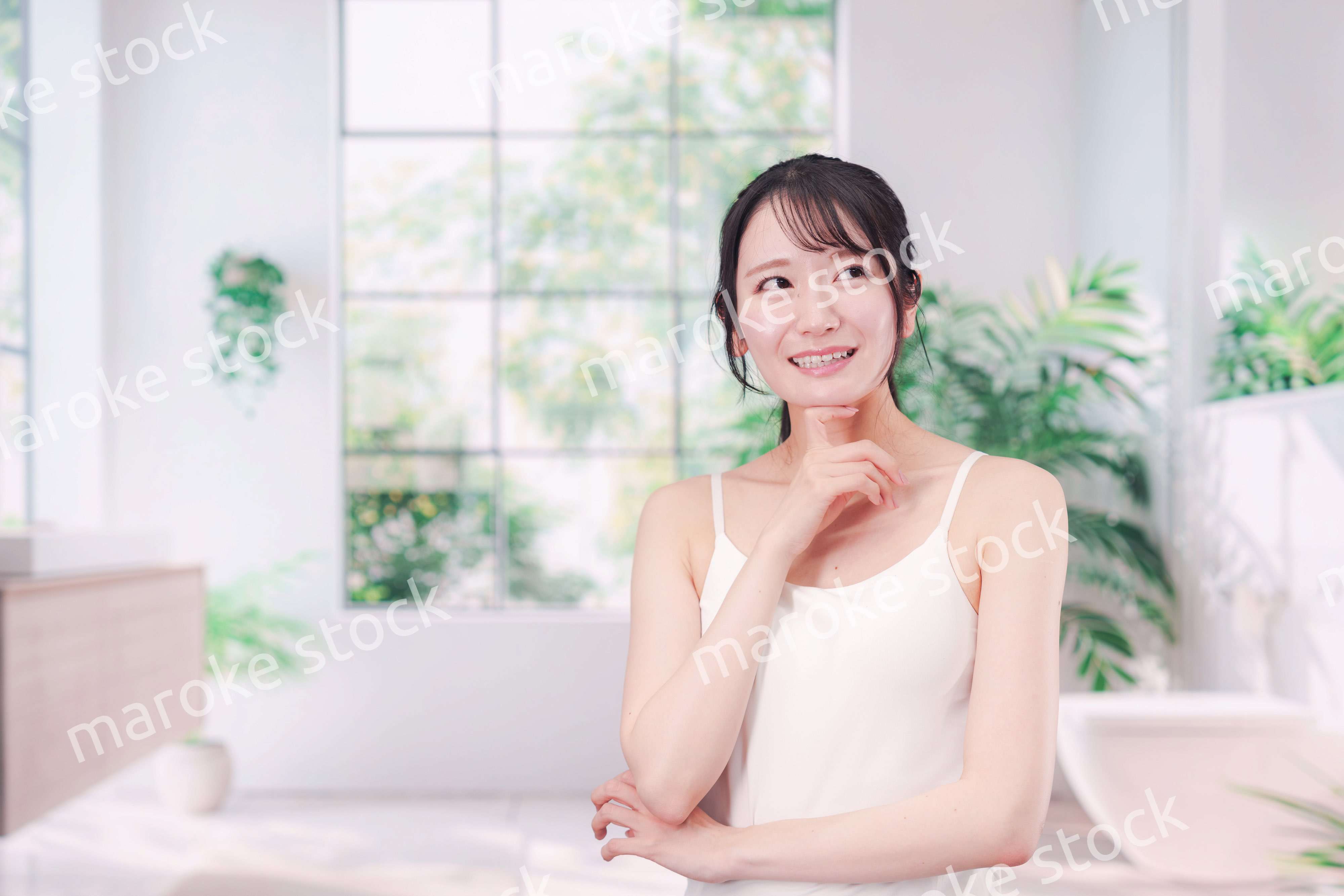 笑顔でビューティーケアをする若い女性