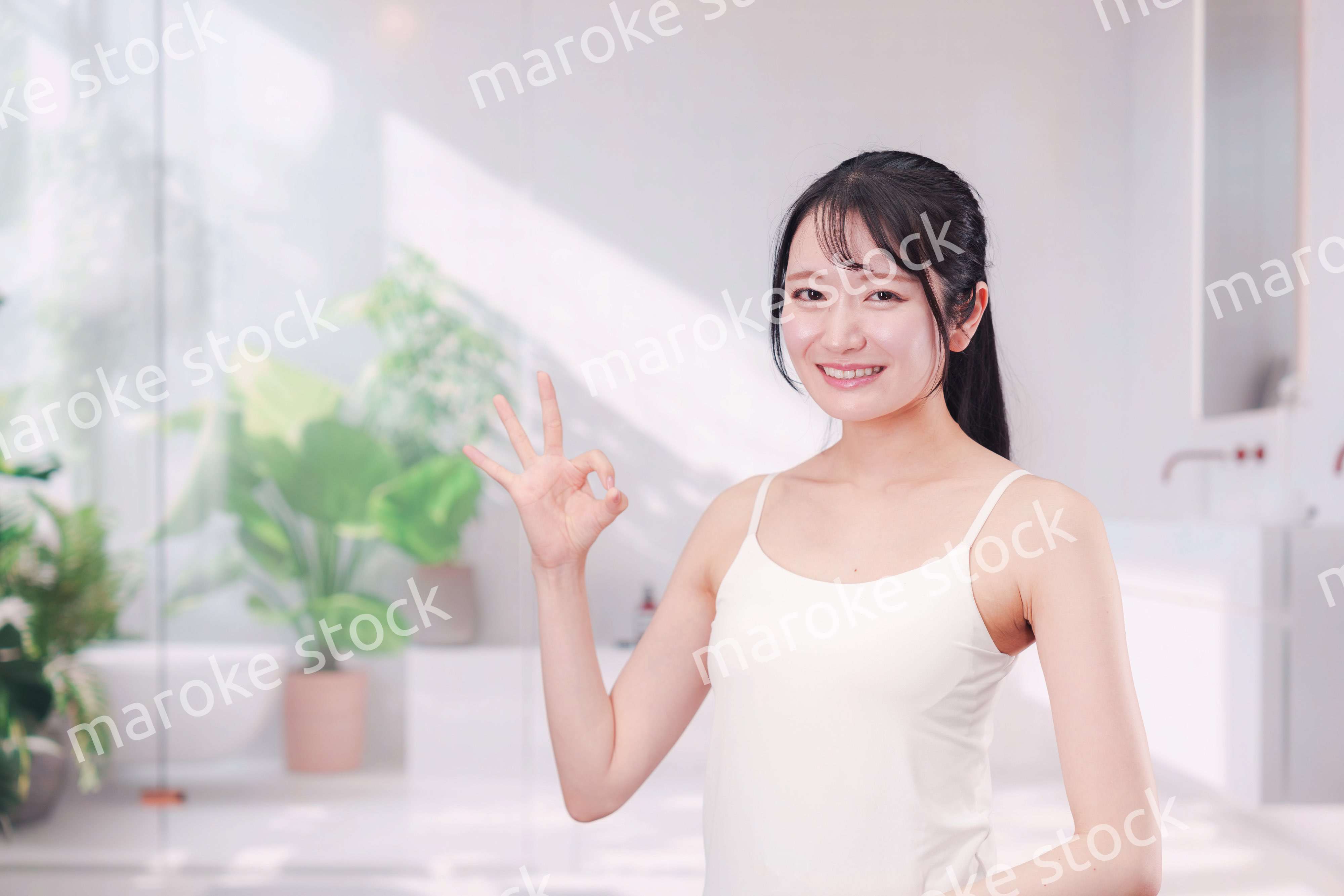 笑顔でビューティーケアをする若い女性