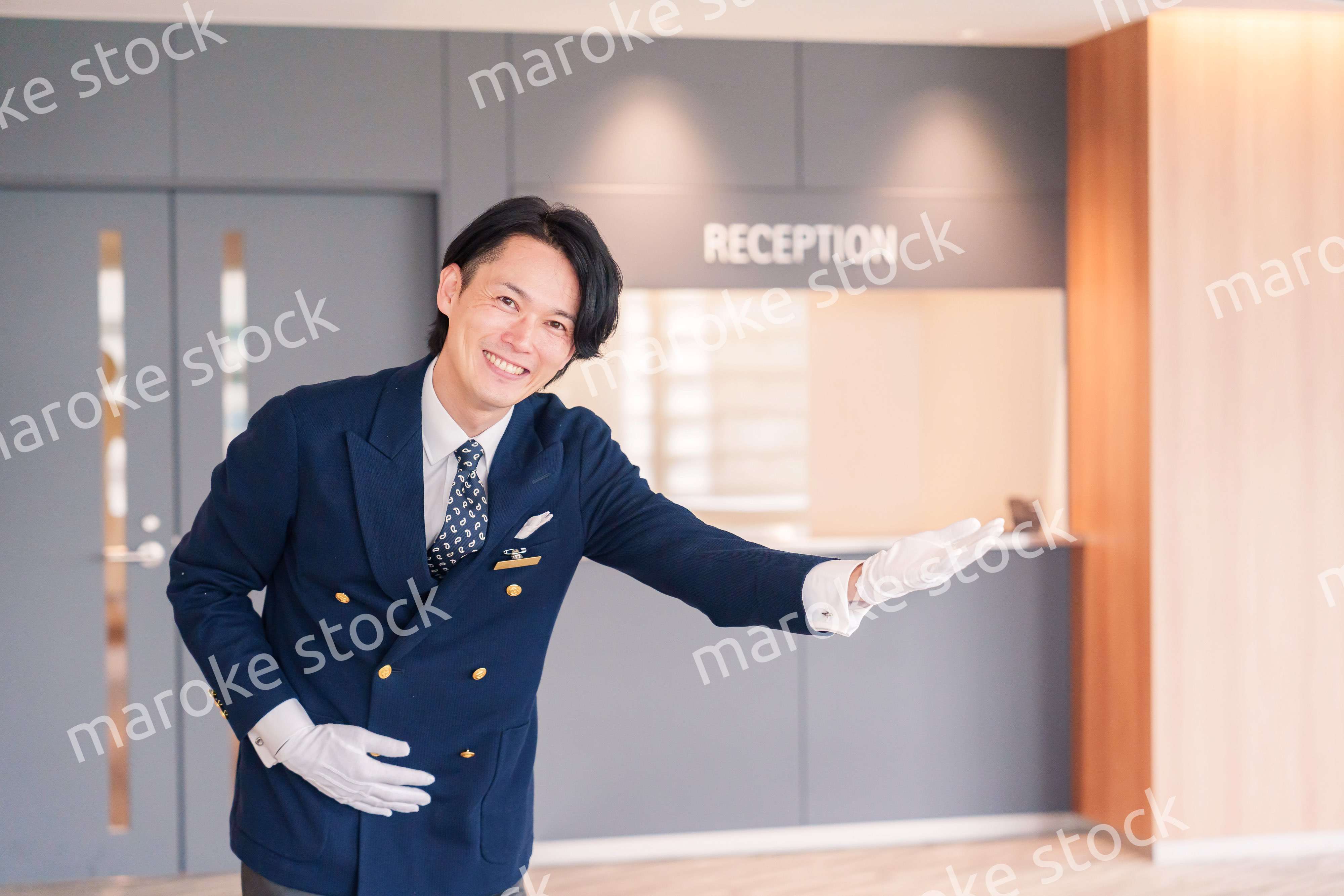 笑顔で接客をするホテルマンの男性