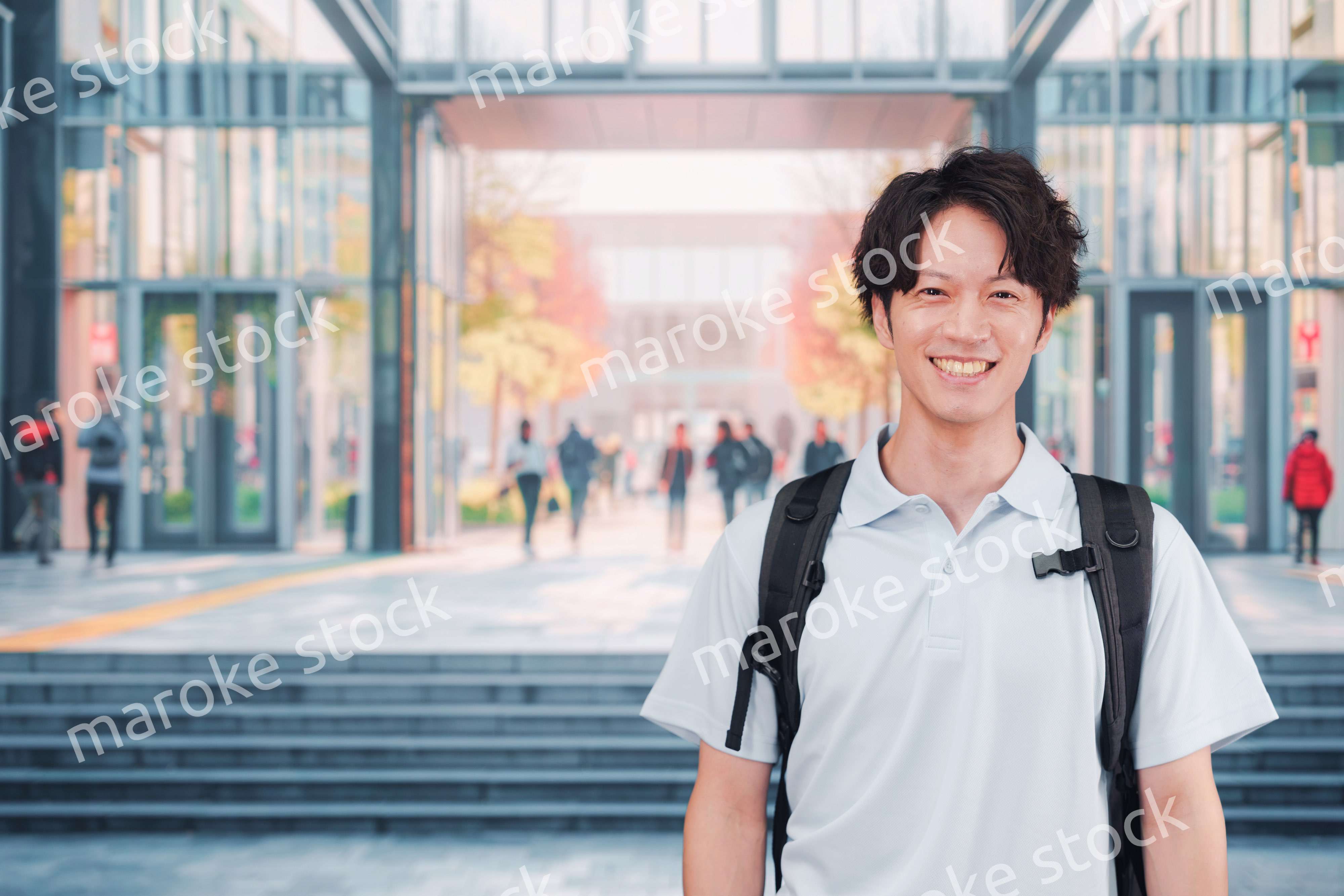 大学のキャンパス内を歩く男子学生