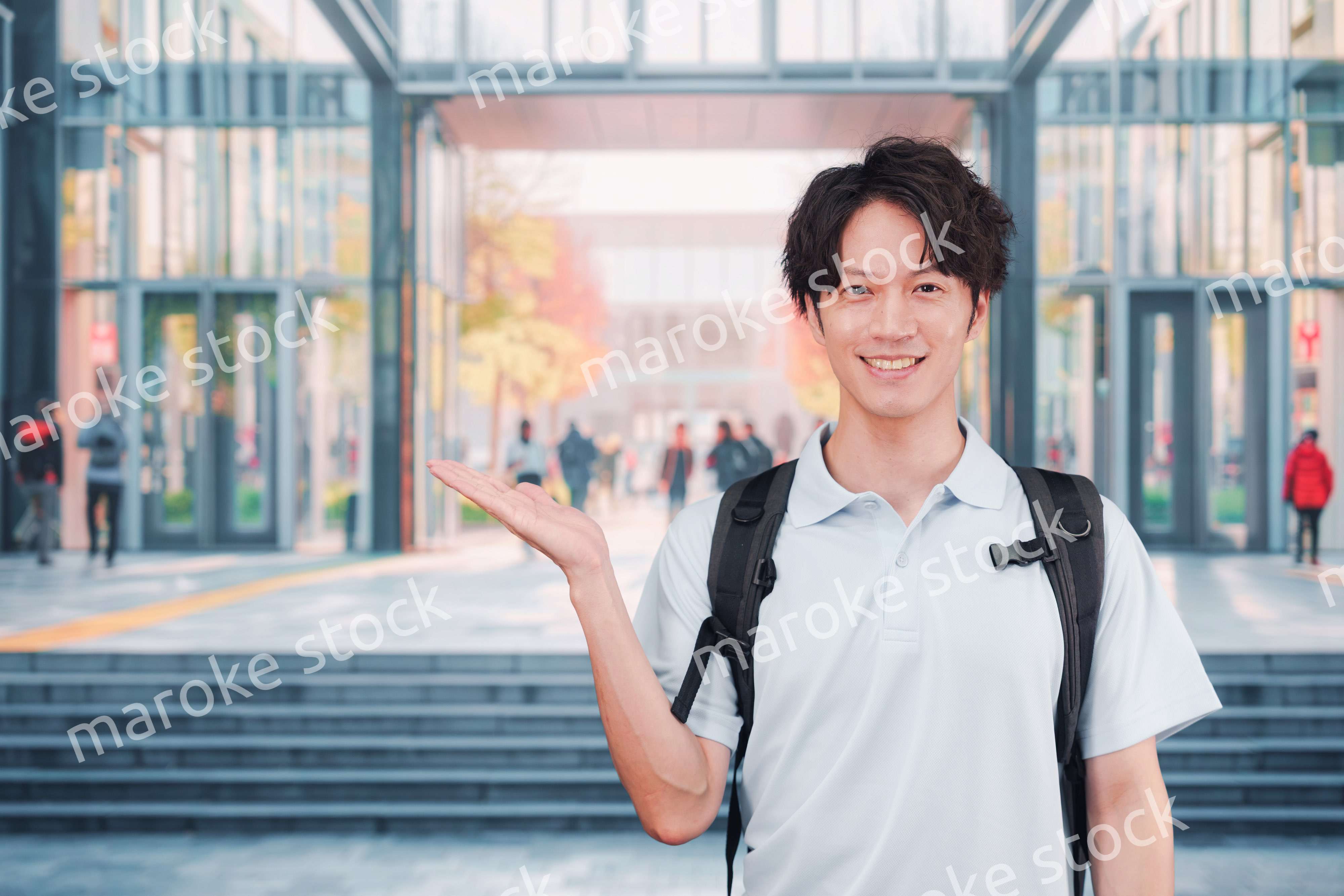 大学のキャンパス内を歩く男子学生