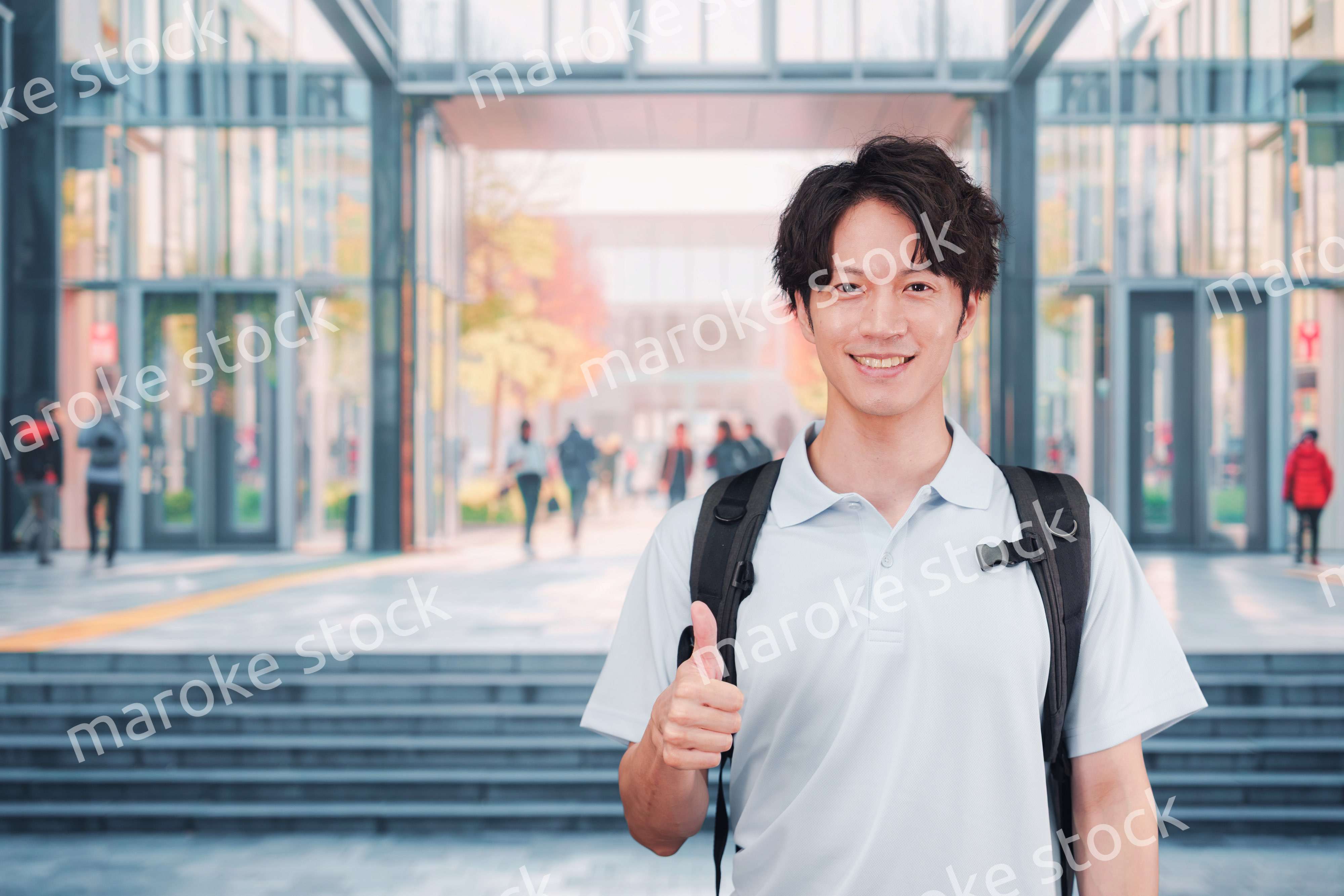 大学のキャンパス内を歩く男子学生