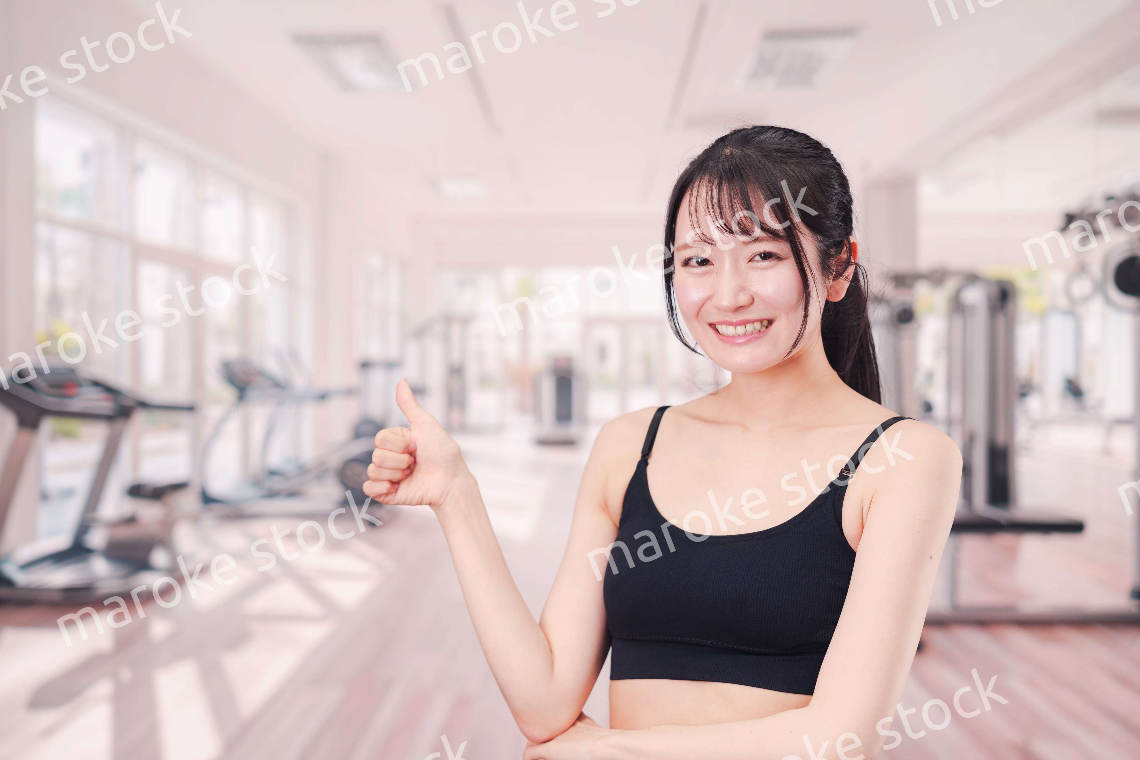 ジムでランニングをする若い女性