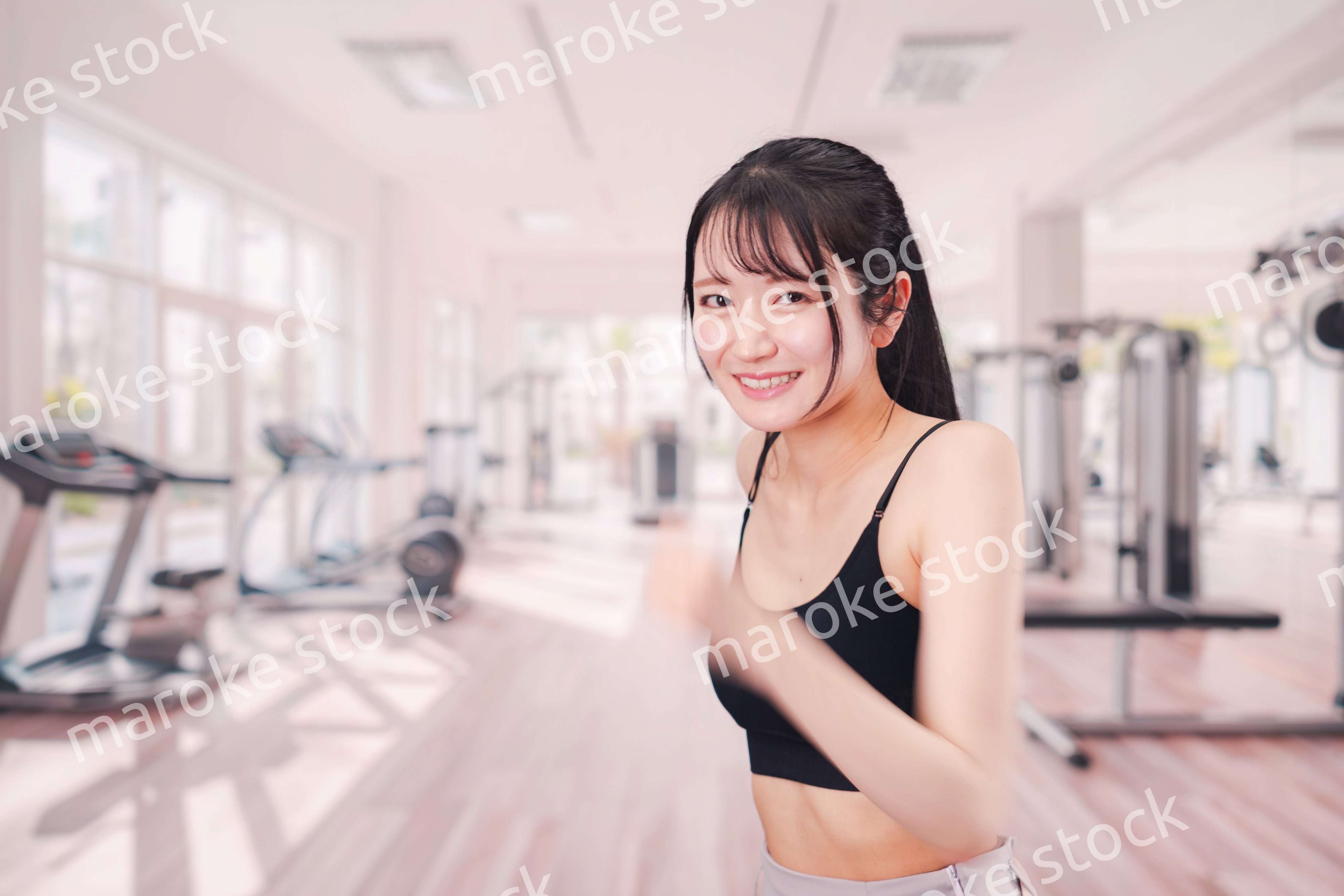 ジムでランニングをする若い女性