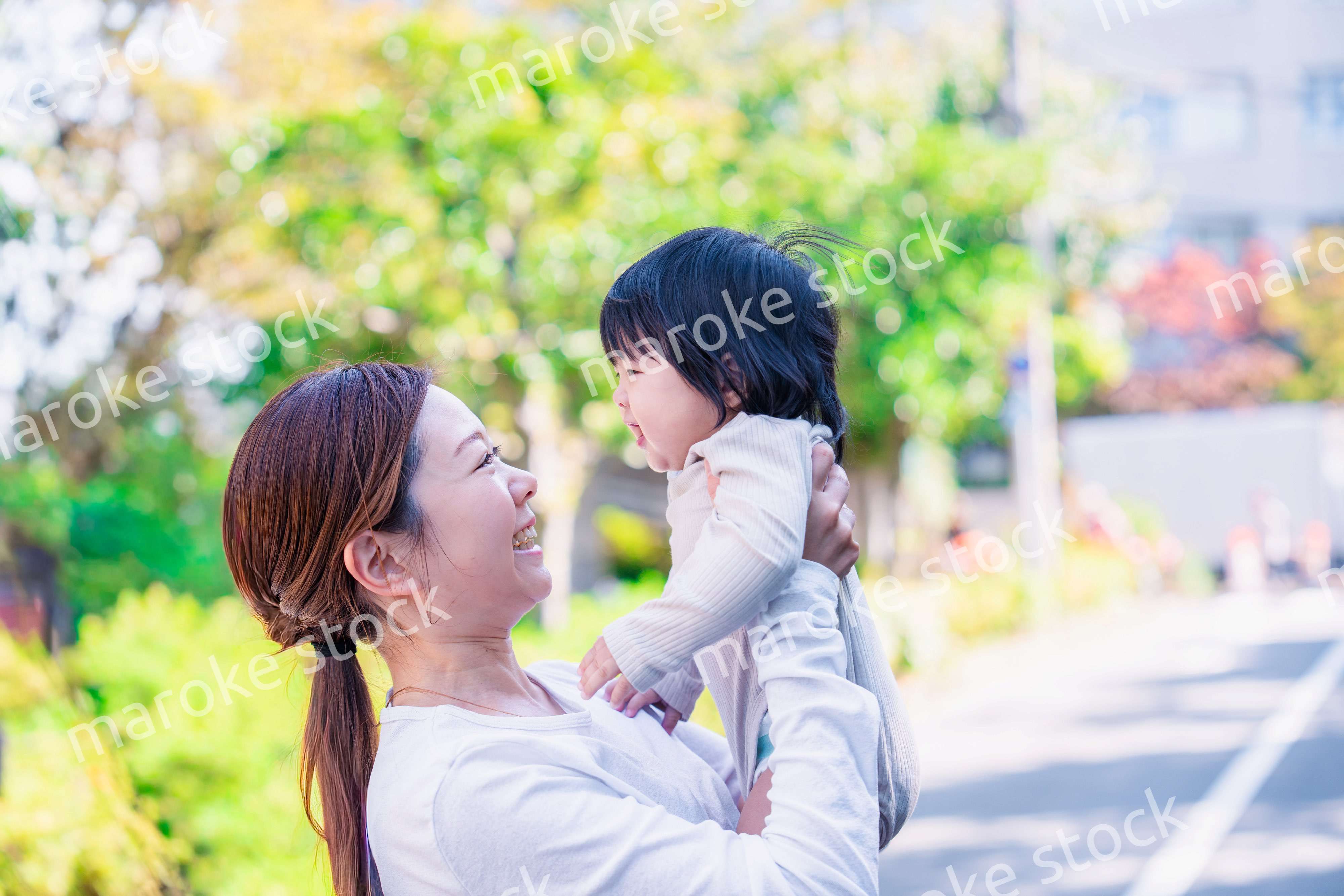 生後半年の赤ちゃんを抱っこして笑うお母さん