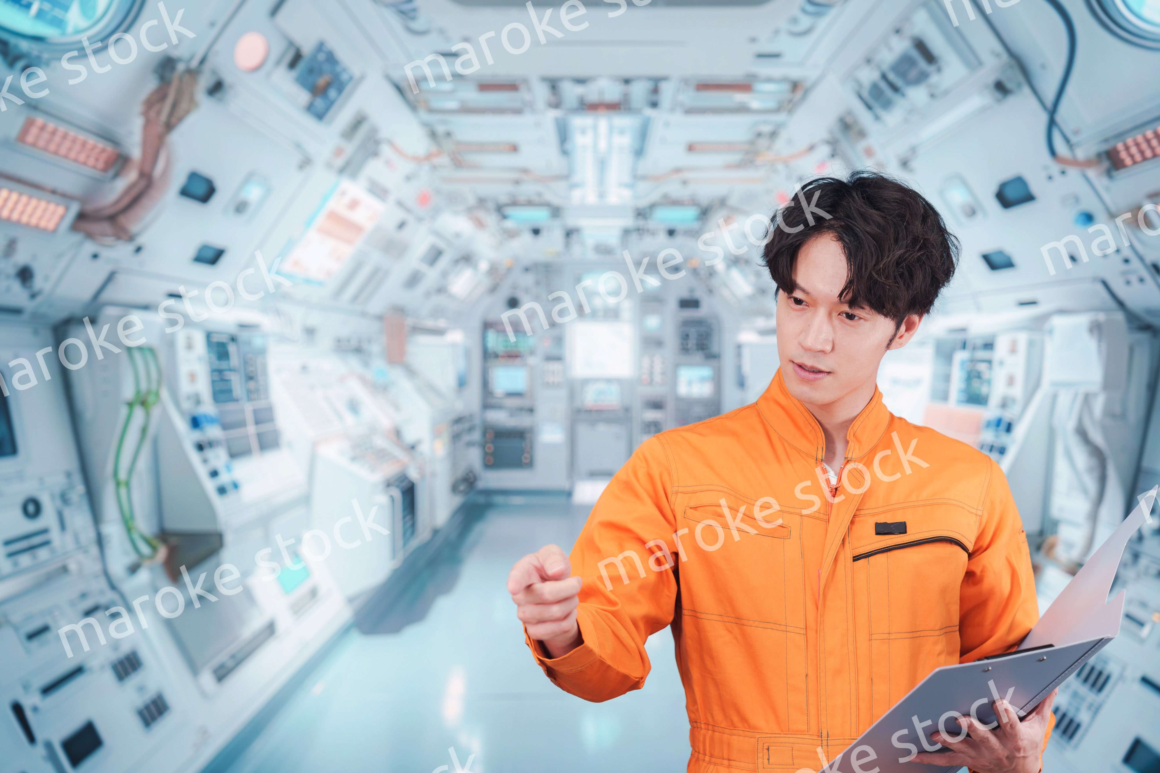 宇宙ステーションの中で働く若い男性の宇宙飛行士