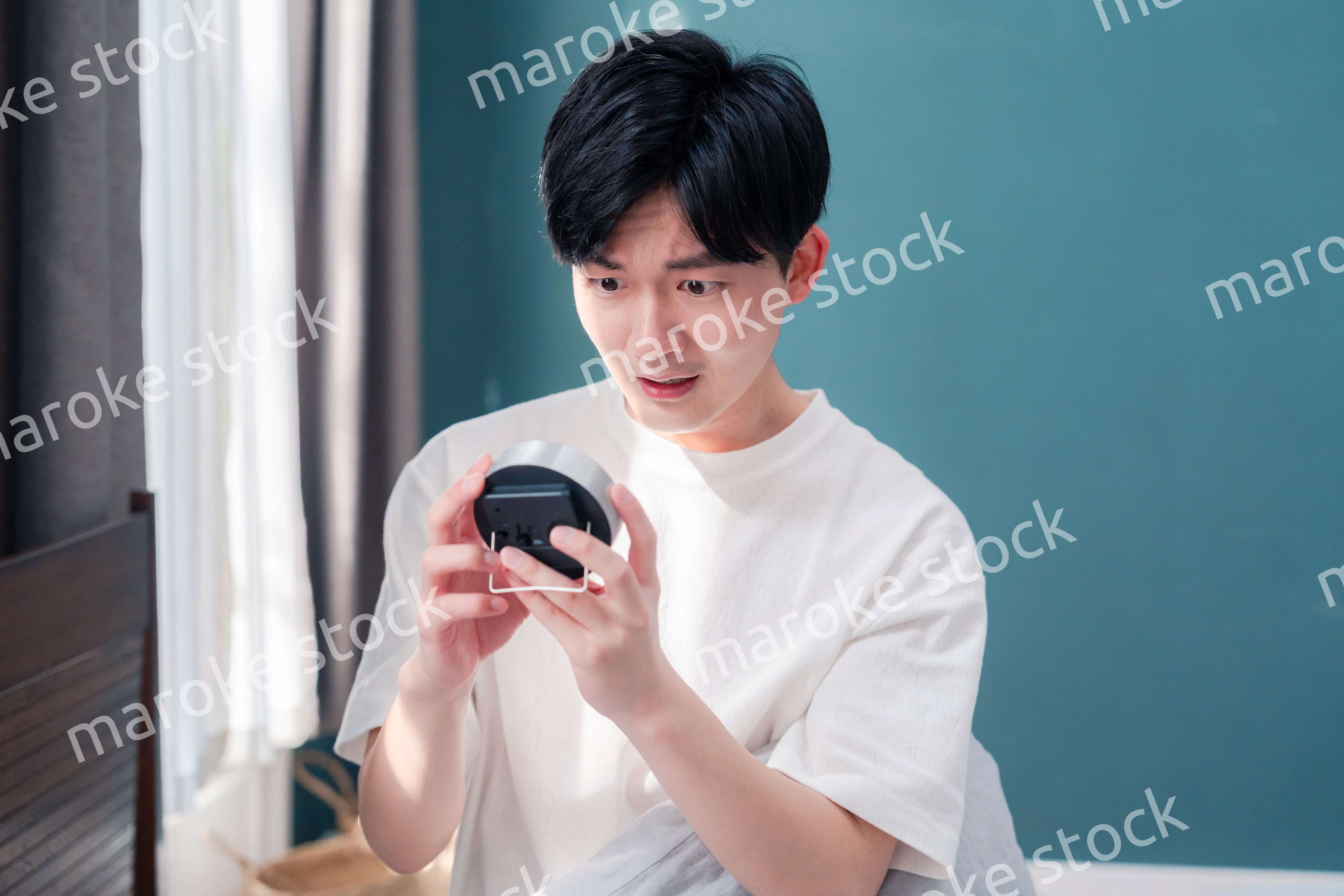 寝坊をして焦る若い男性