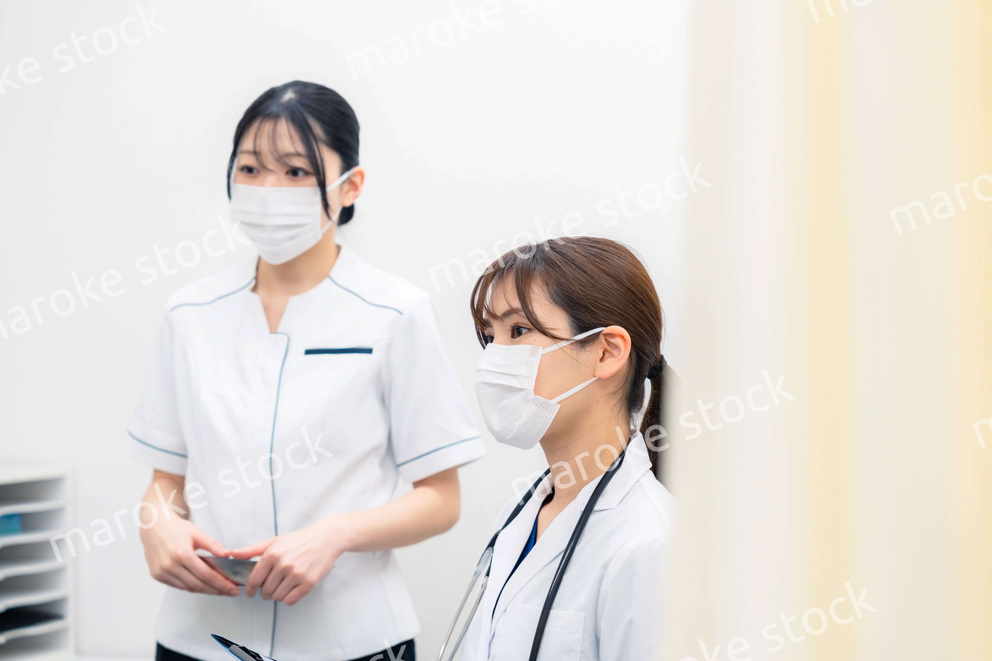 患者の治療をする2人の若い医療従事者