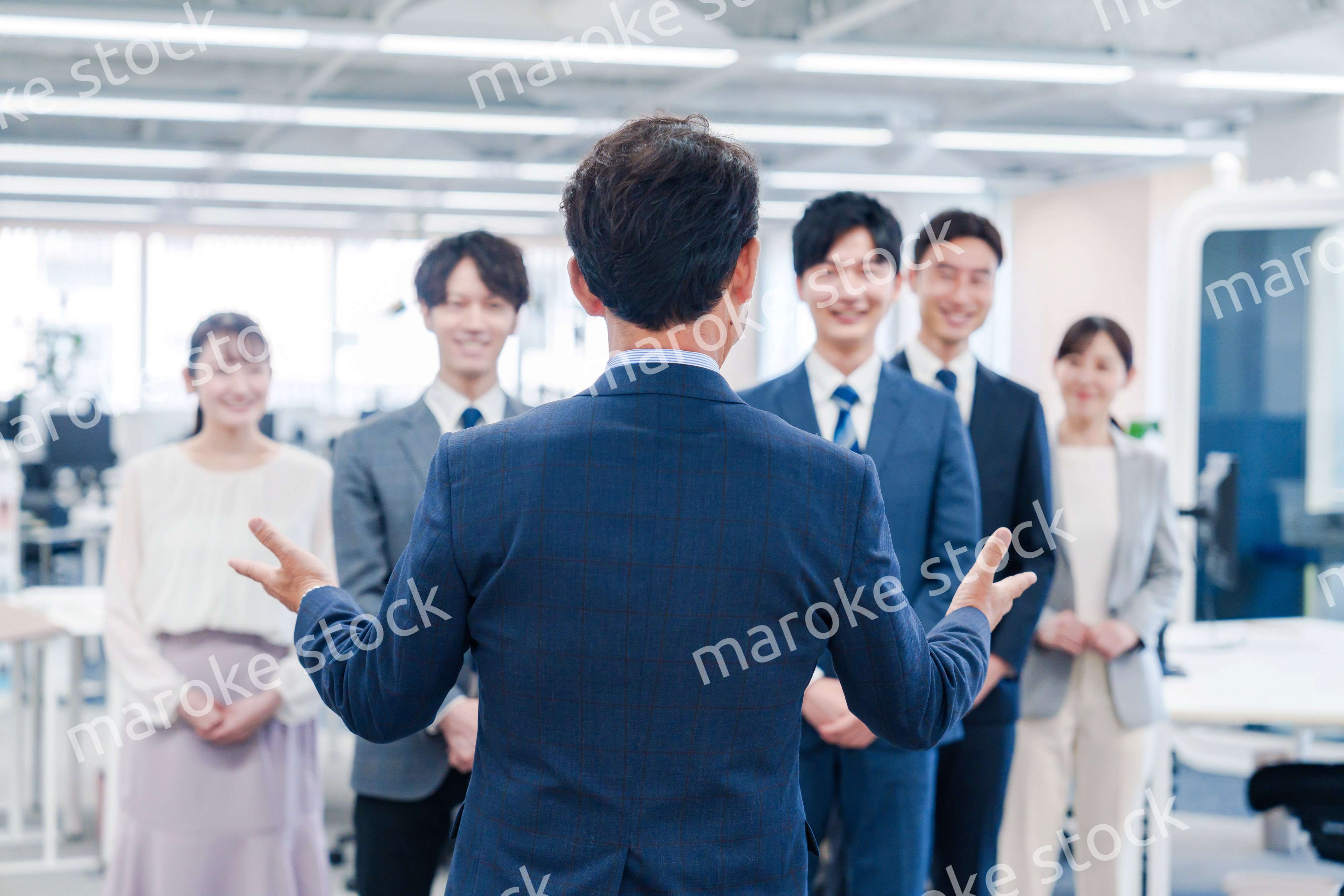 オフィスで朝会をするビジネスパーソン