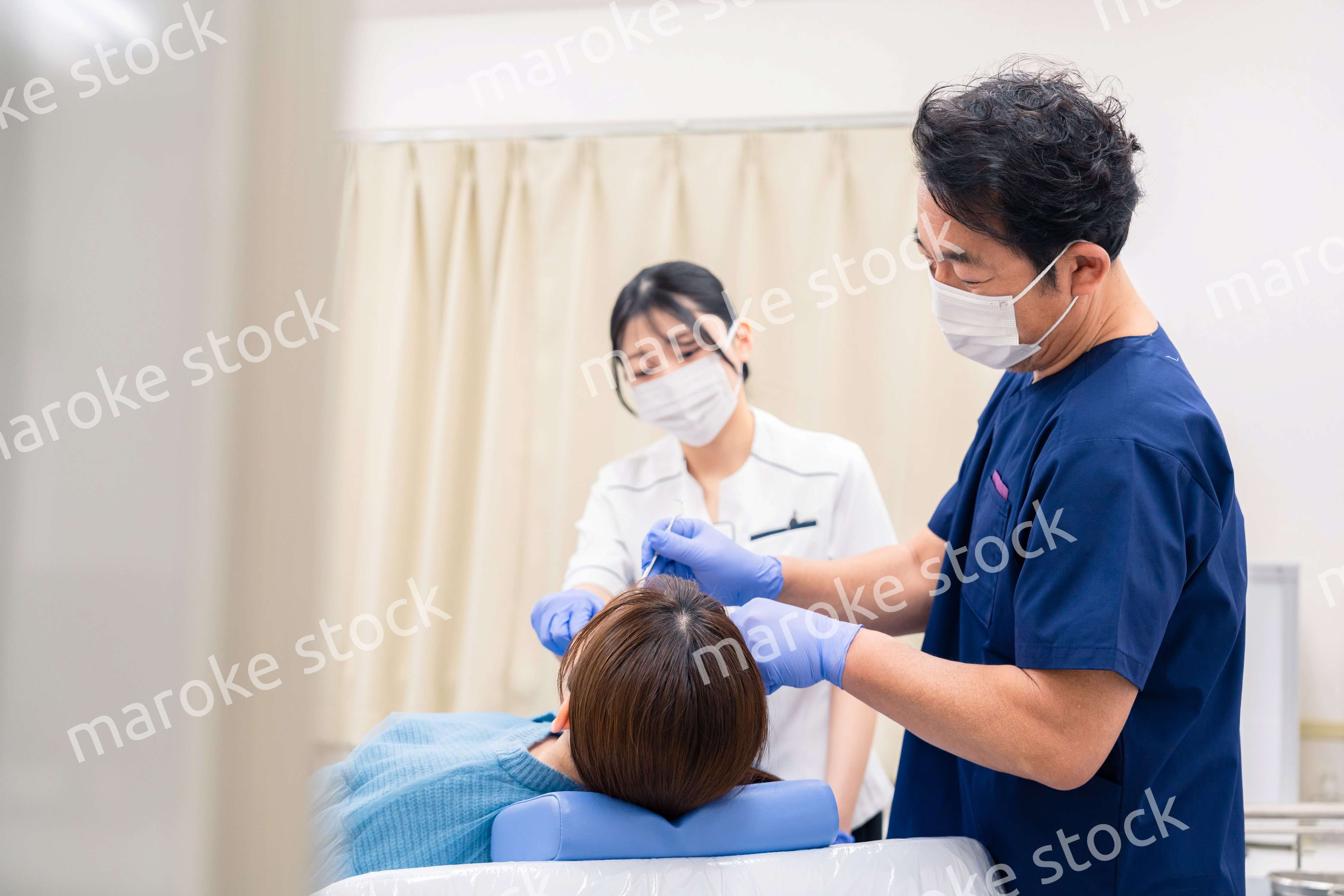 歯科治療をする歯医者の男性