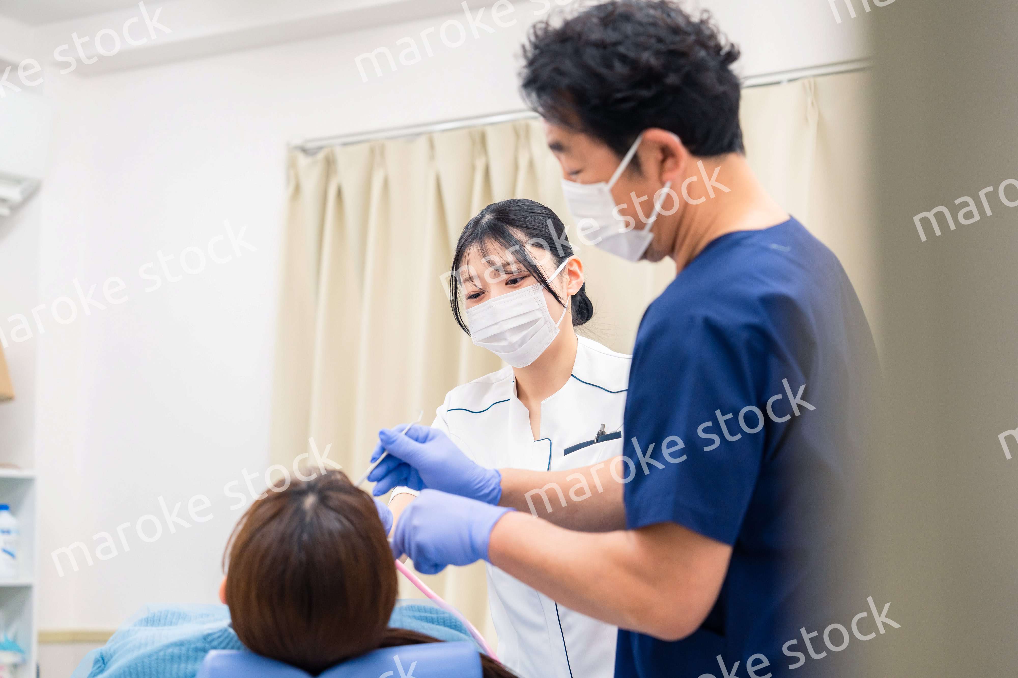 歯科治療をする歯医者の男性