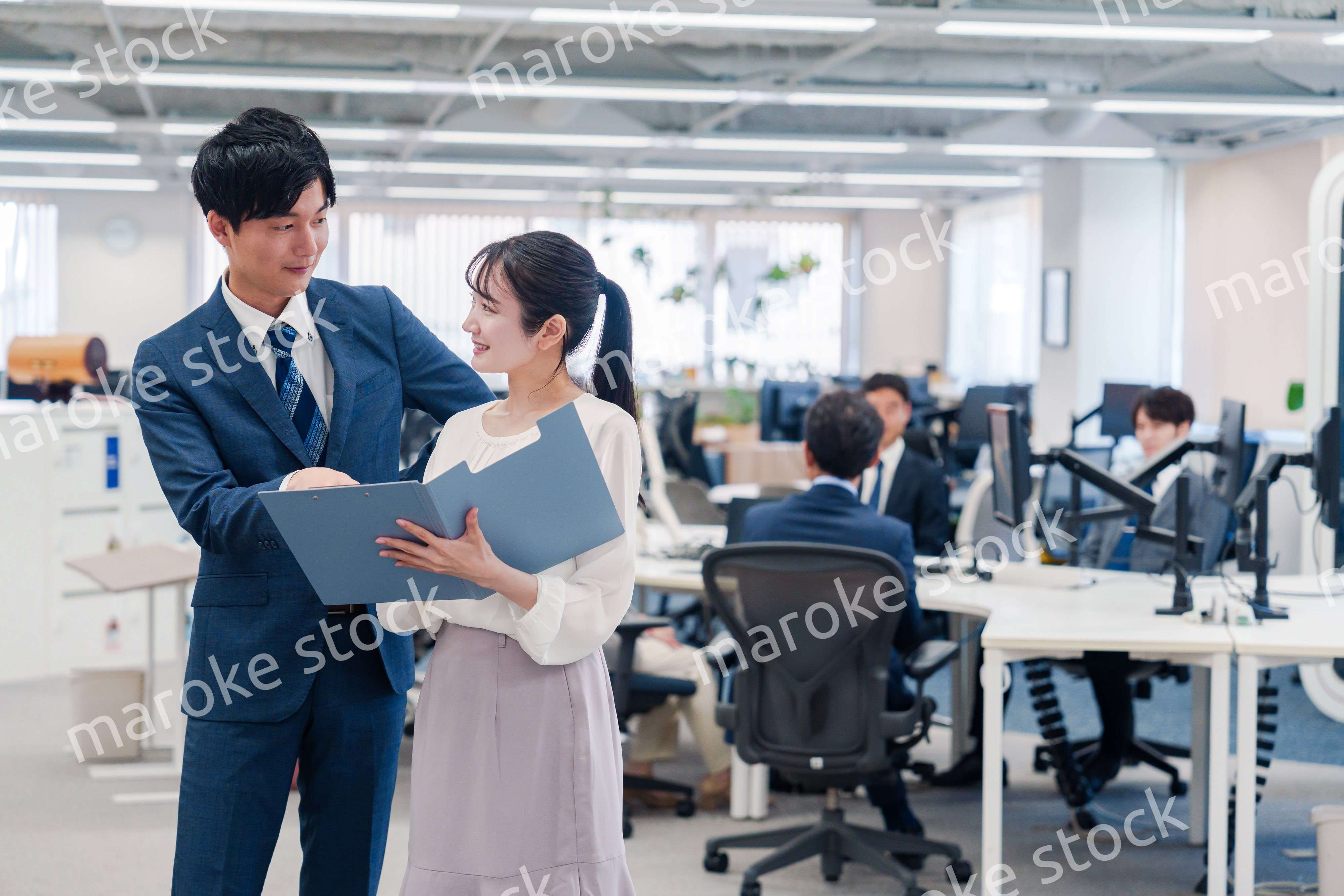 オフィスで先輩に相談をする若い女性