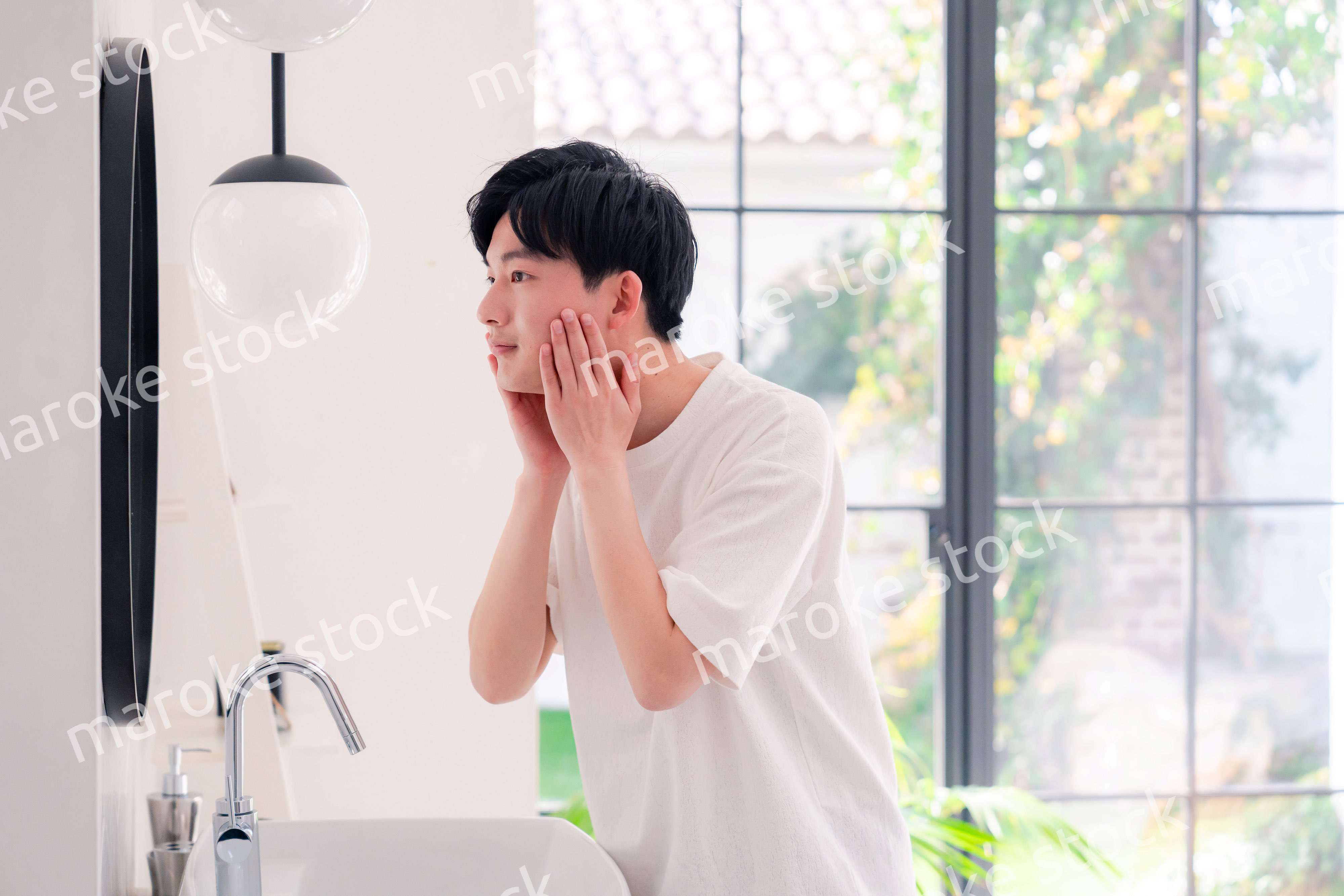 洗面所で身だしなみを整える若い男性