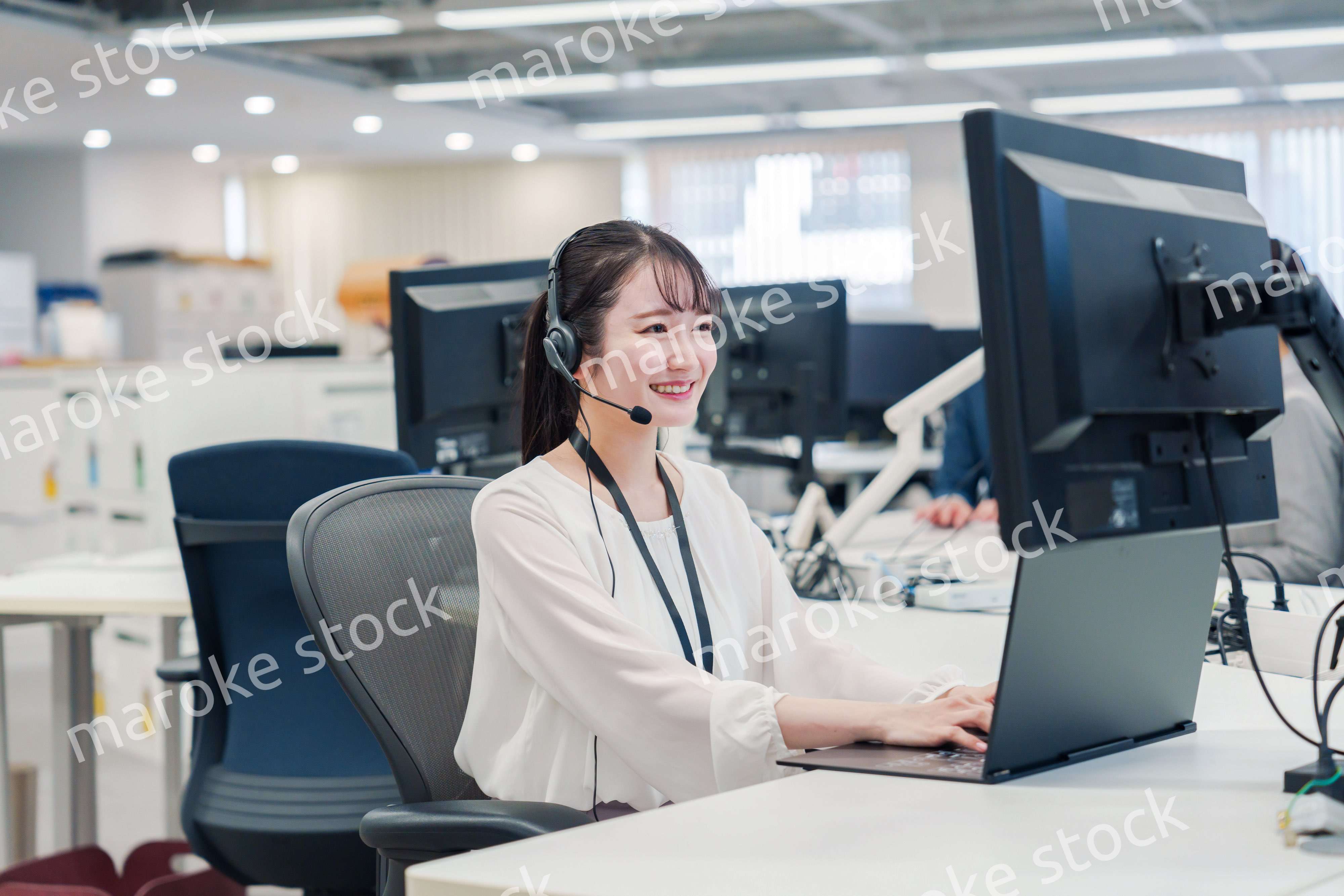 コールセンターでお客さま対応をするオペレーターの女性