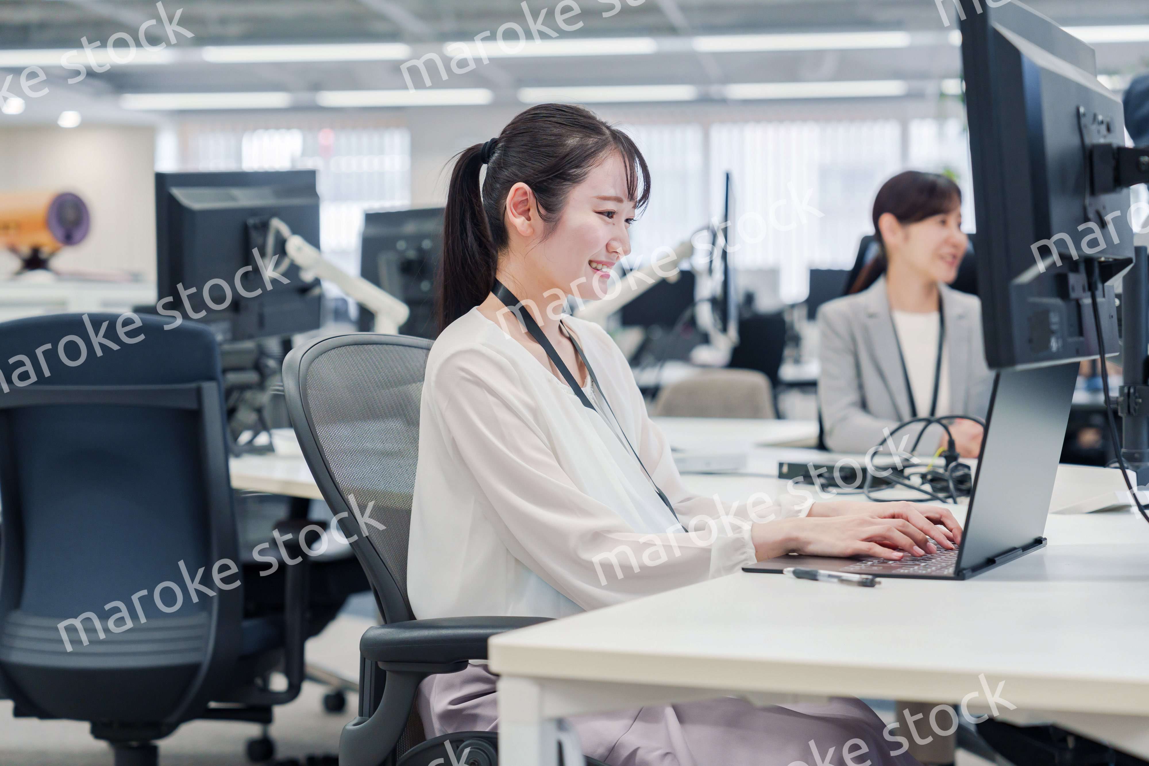 オフィスでデスクワークをする妊婦の女性