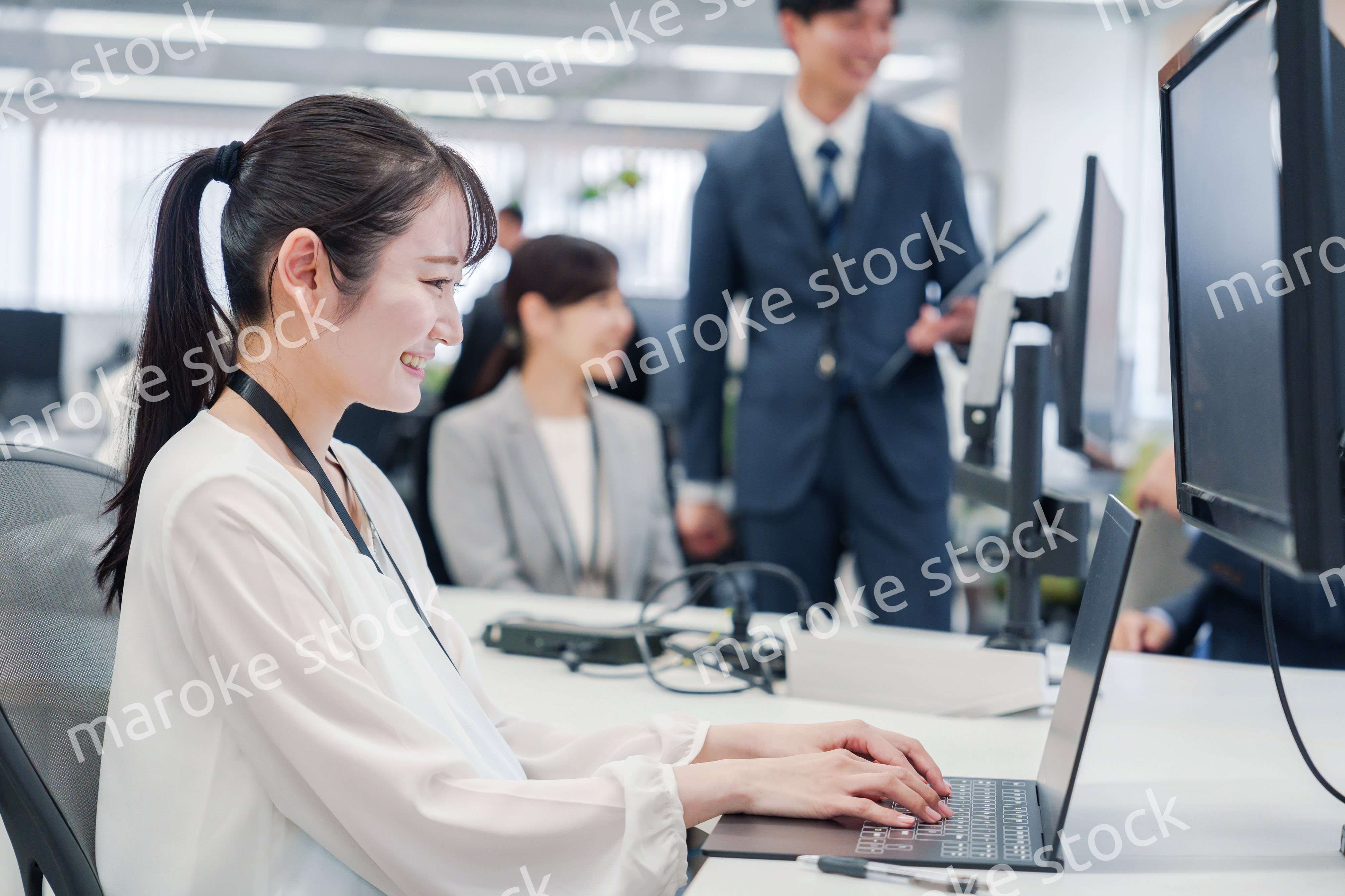 オフィスでデスクワークをする妊婦の女性