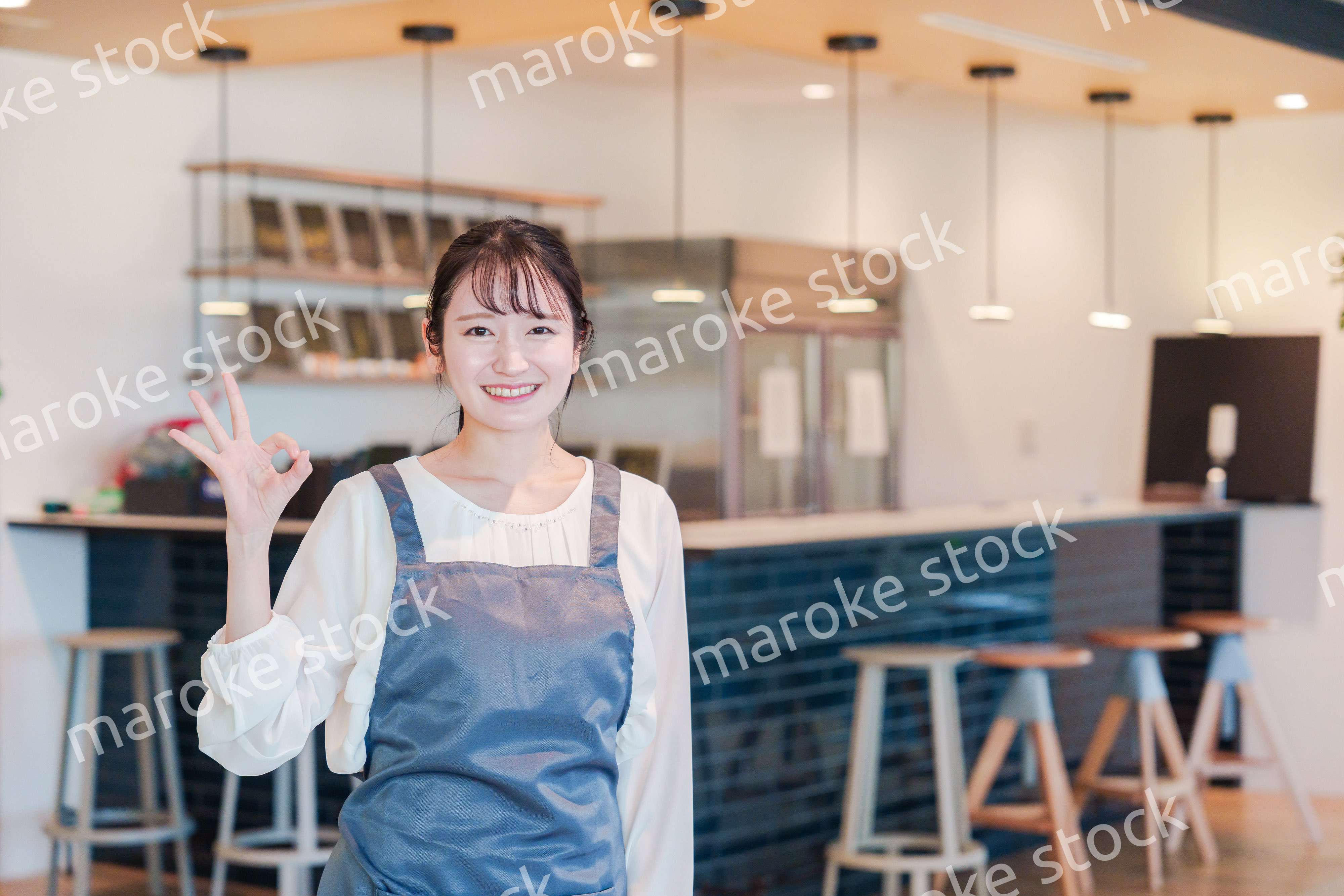 笑顔で働くカフェスタッフの女性