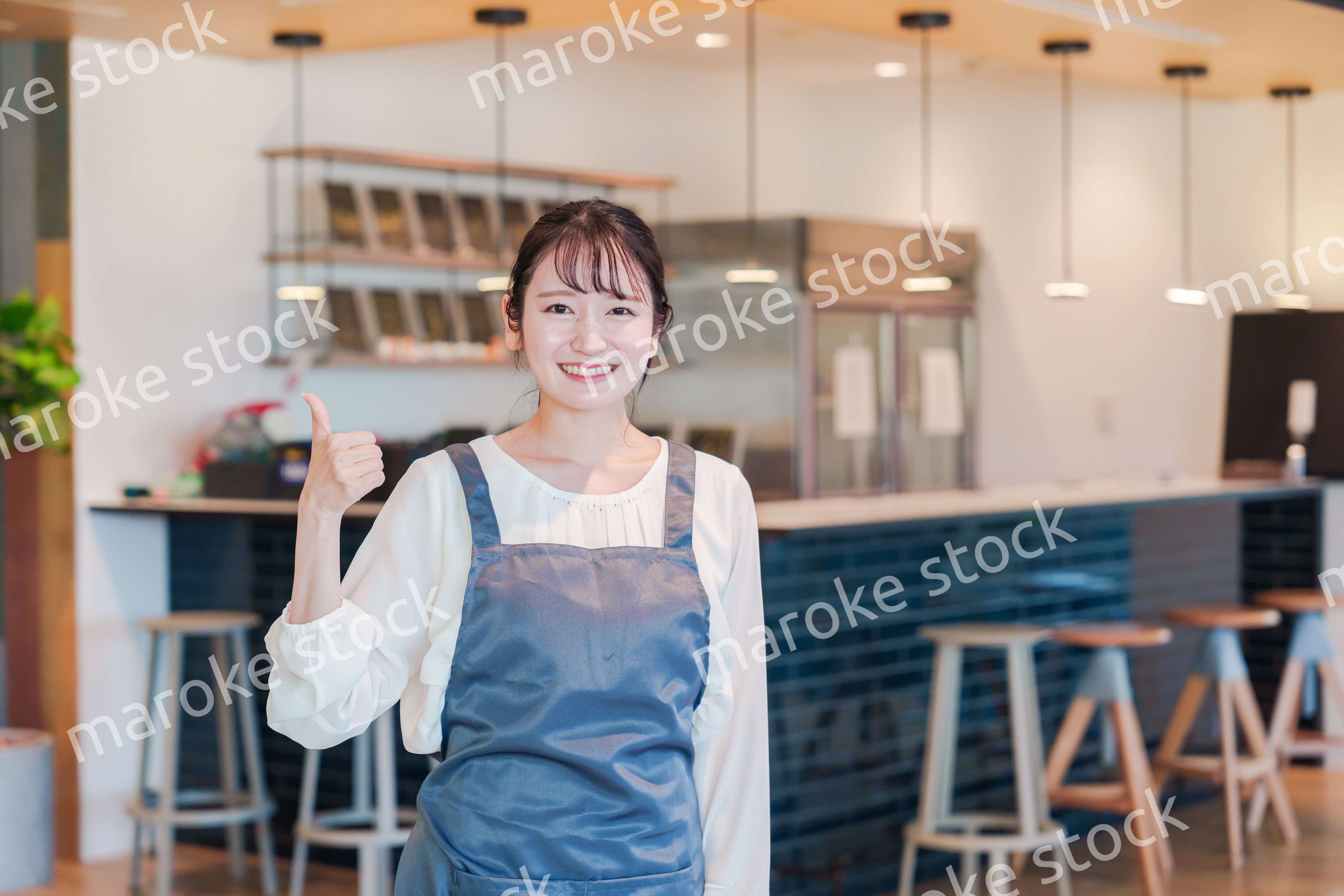 笑顔で働くカフェスタッフの女性