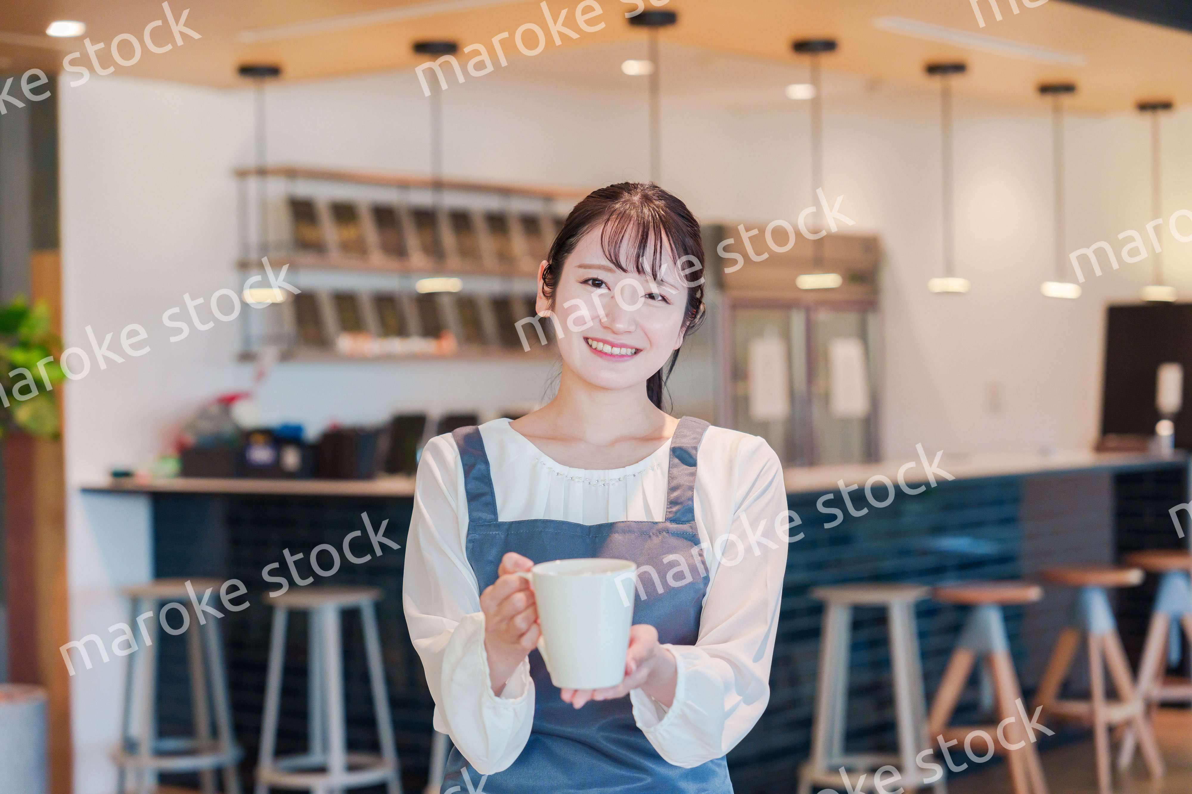 笑顔で働くカフェスタッフの女性