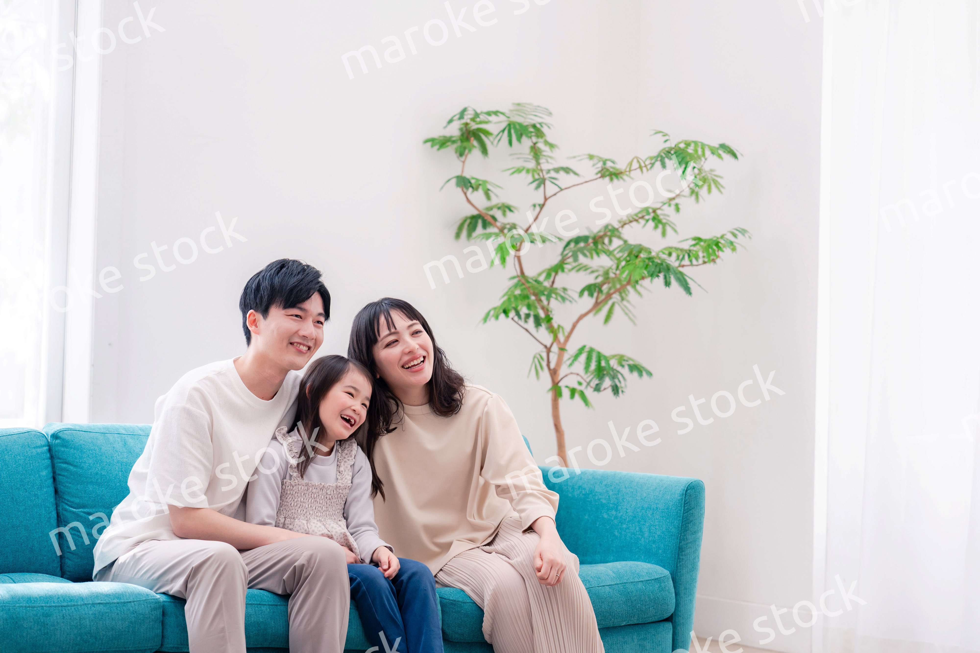 リビングでみんなでテレビを見るファミリー